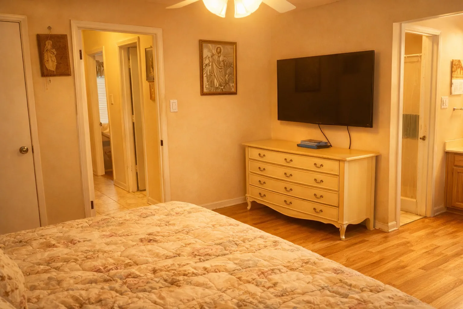 Interior space featuring wood-finish flooring, a ceiling fan, and light-toned walls