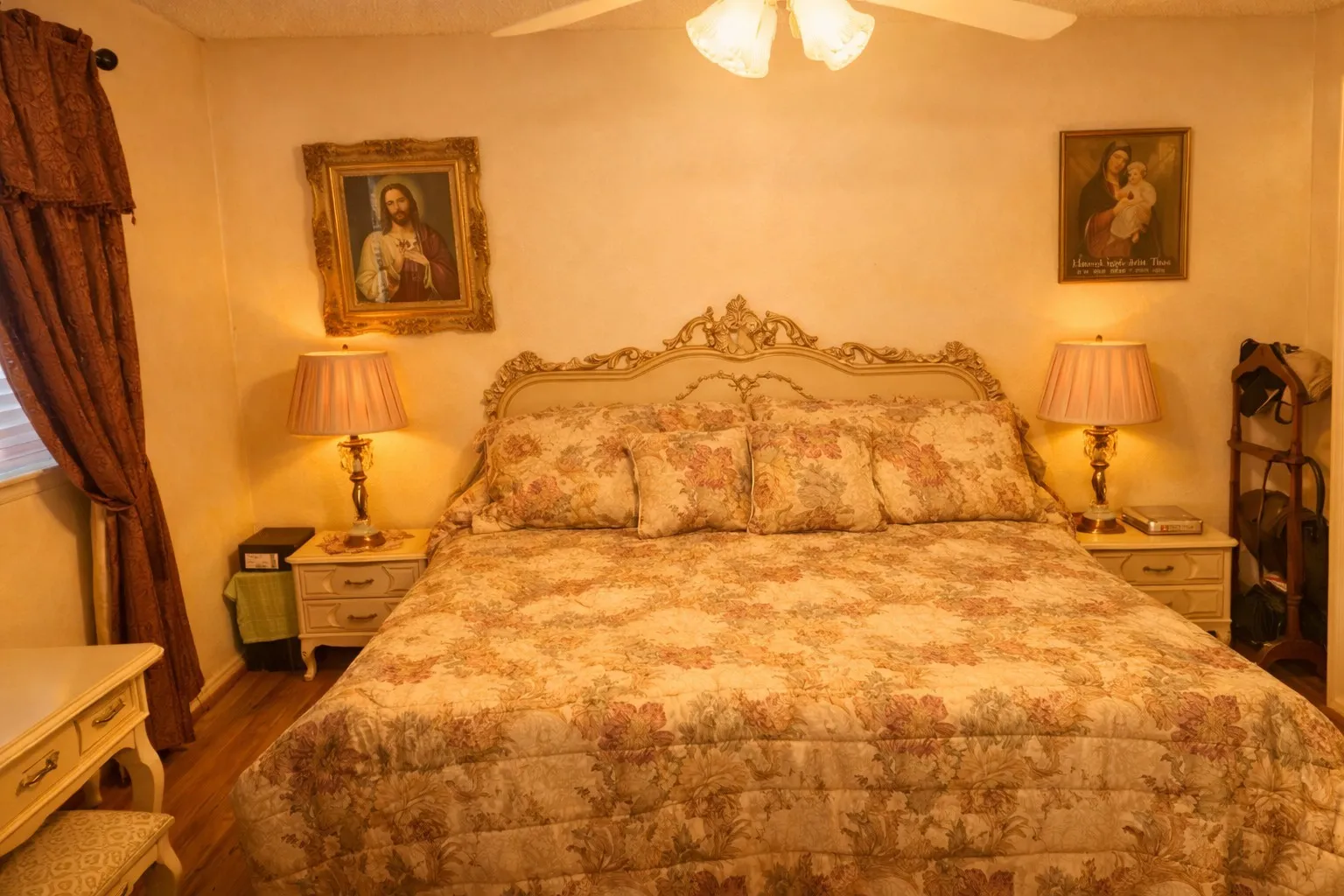 Bedroom featuring a decorative headboard, wood-finish flooring, and a ceiling fan with light fixture