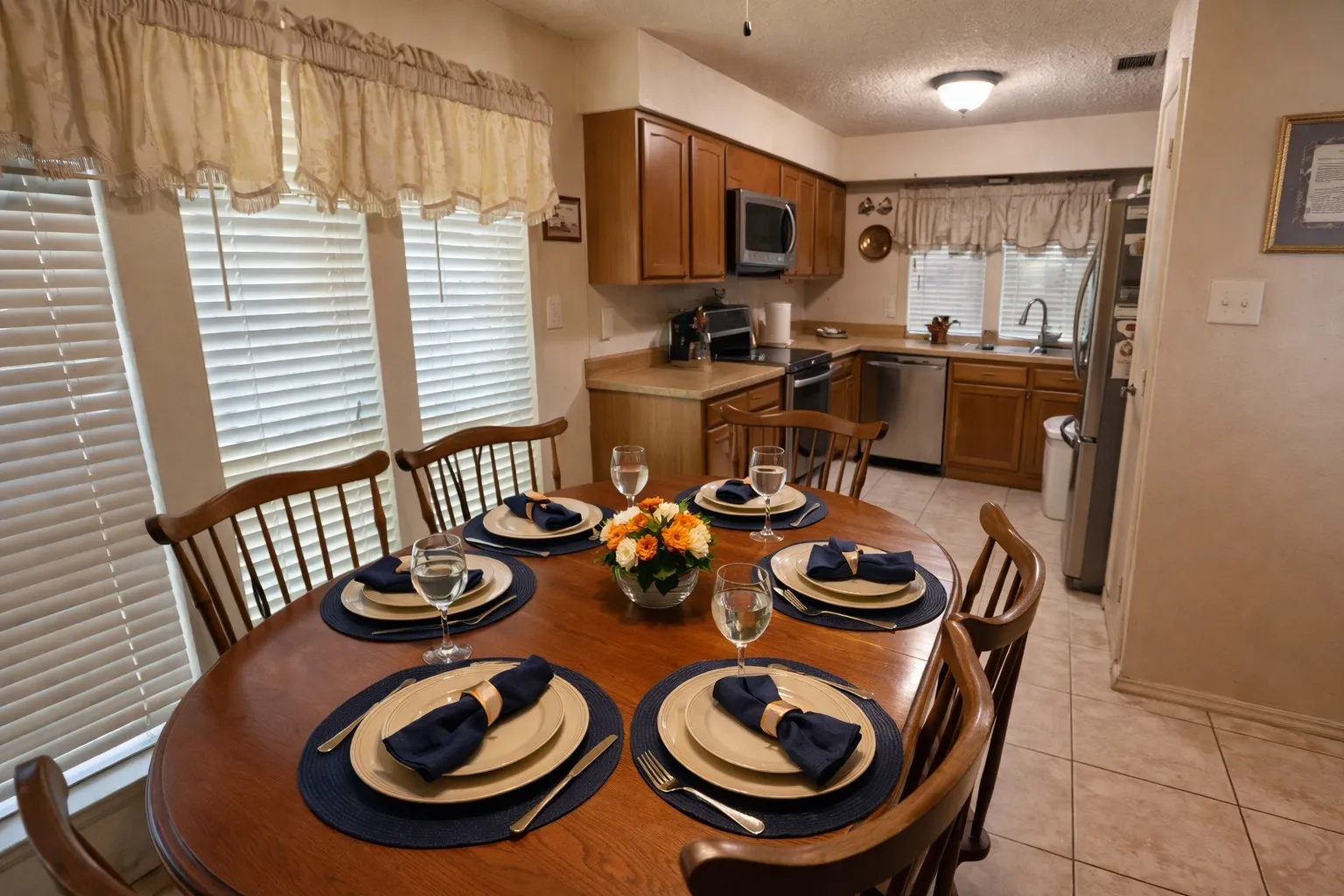 Kitchen with wood cabinetry, stainless steel appliances, and a tile floor