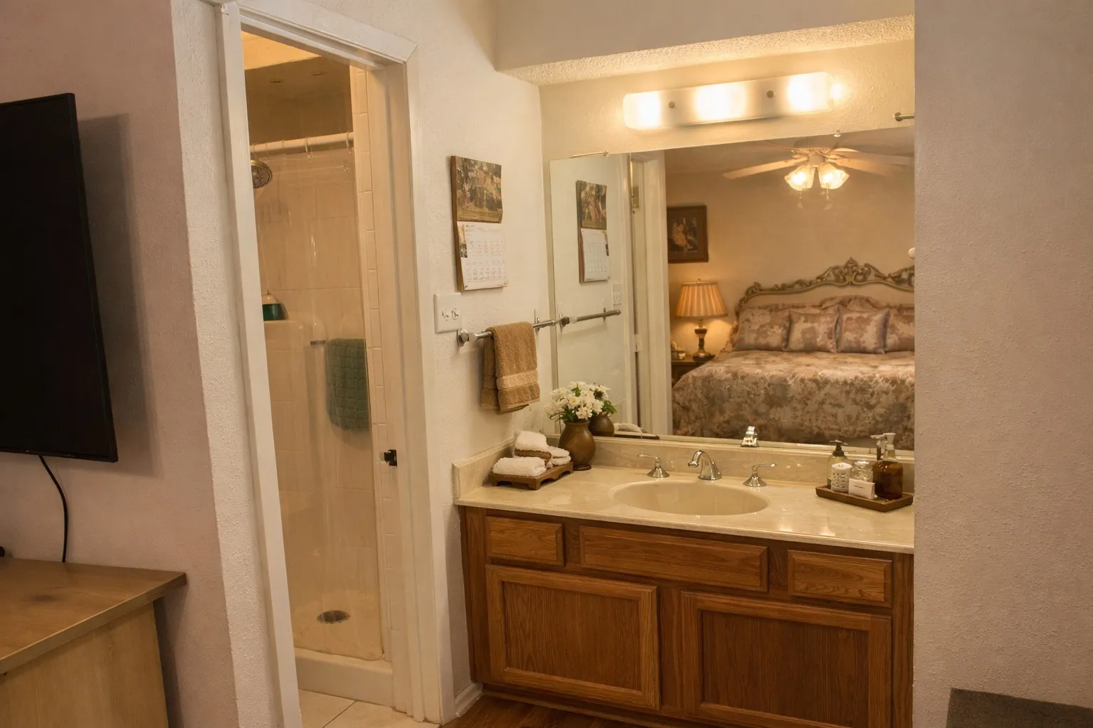 Bathroom vanity featuring a light-toned countertop with an integrated sink, polished chrome faucet, and wood-finish cabinetry