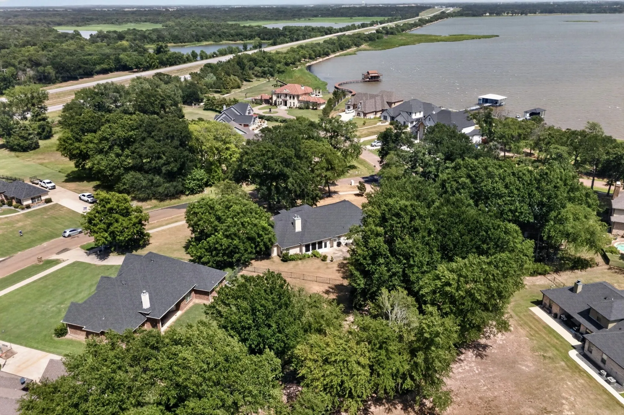 Aerial perspective showcasing a residential area with lake frontage