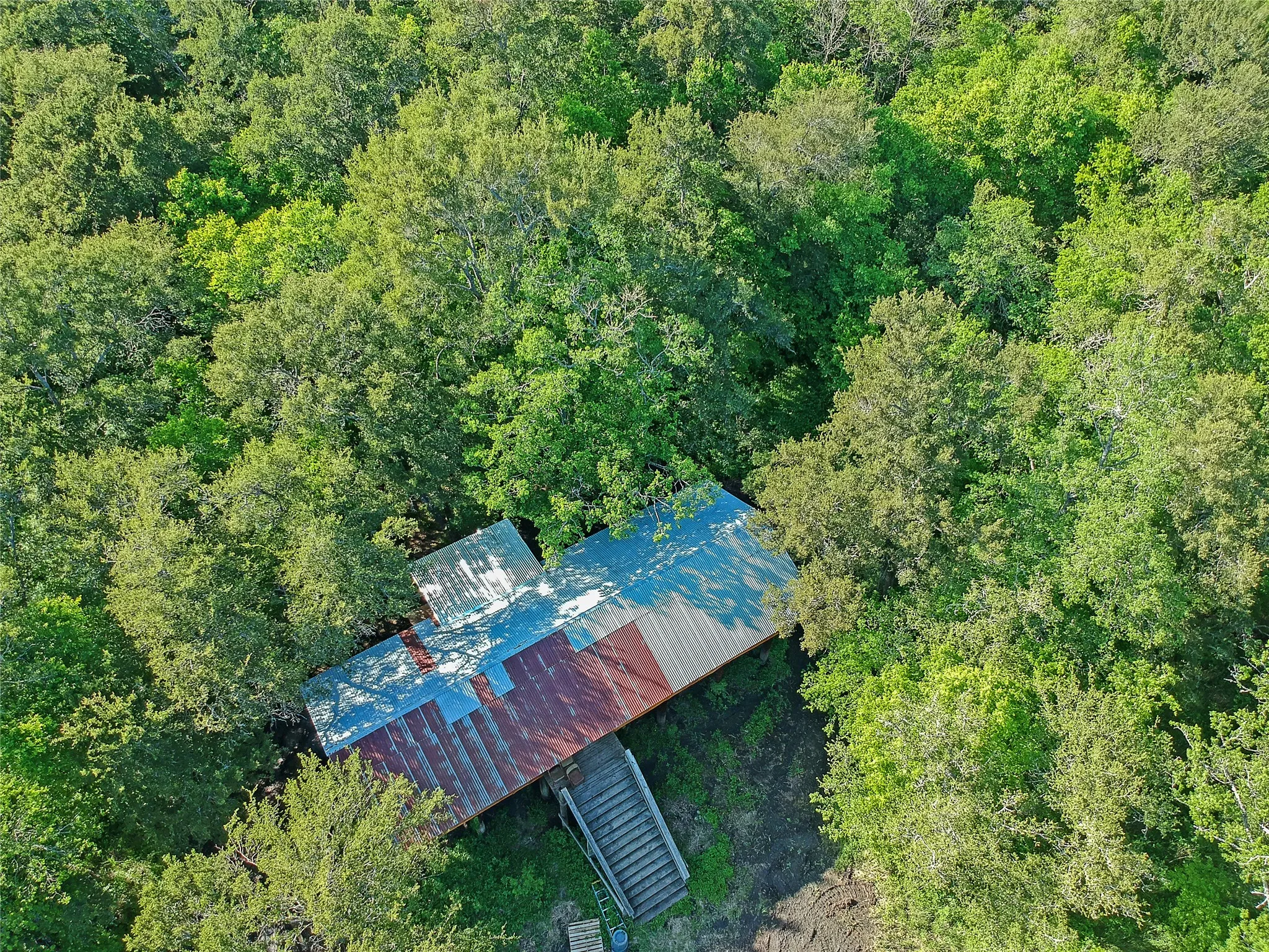 Rustic structure featuring a combination of corrugated metal roofing