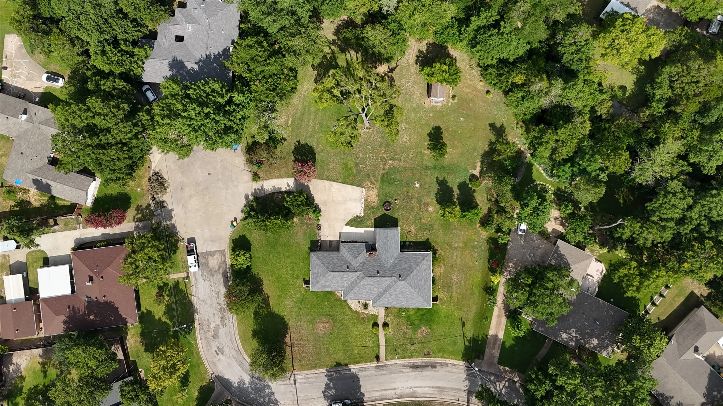 Expansive lot featuring mature trees and a manicured lawn