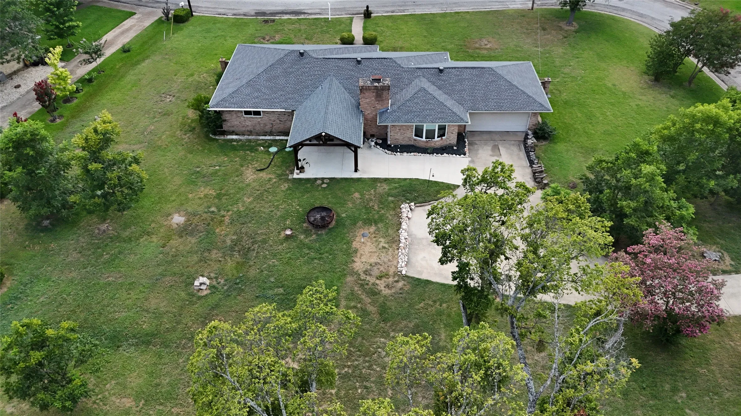 Single-story brick residence featuring a charcoal shingle roof and an attached two-car garage