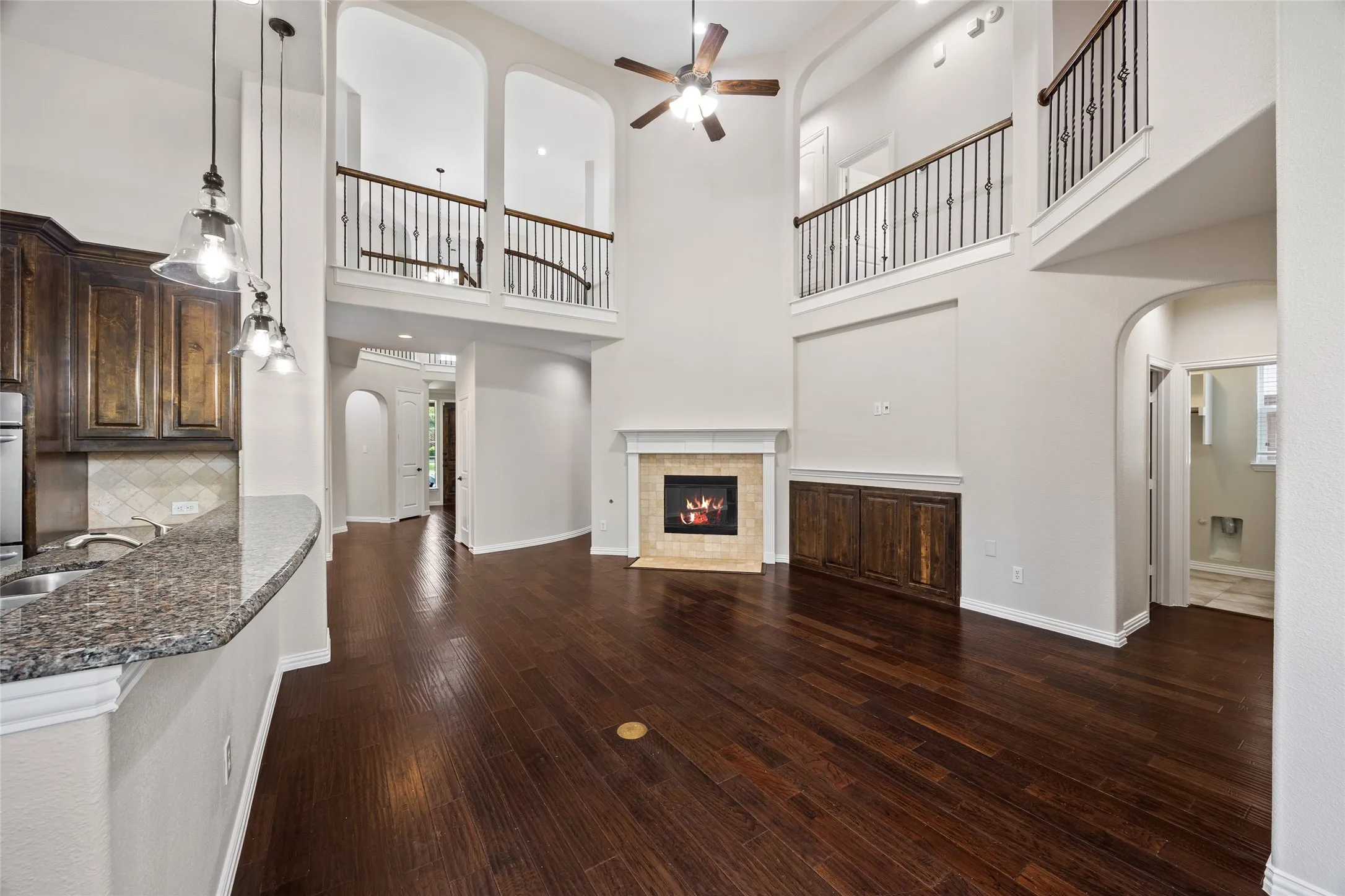 Spacious interior featuring soaring ceilings and dark wood-finish flooring