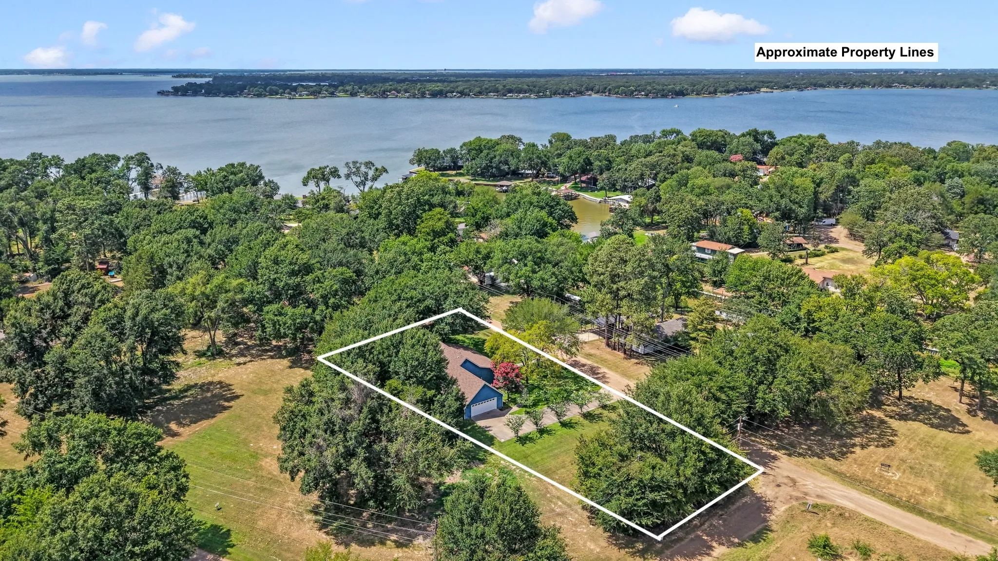 Aerial view highlighting the oversized double lot and close proximity to the lake.