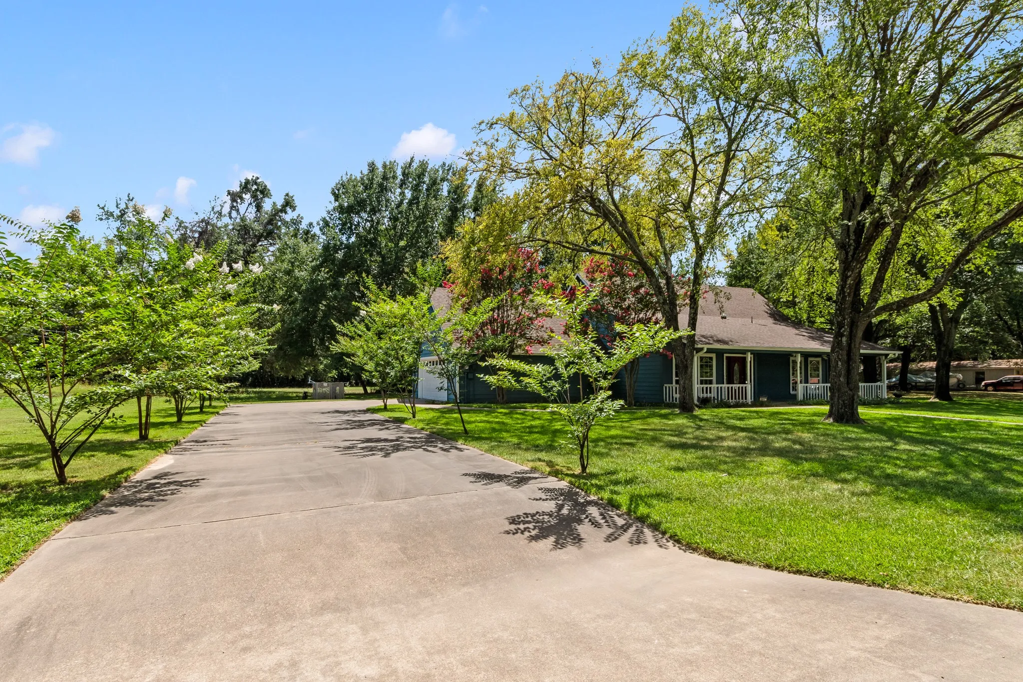 Spacious driveway provides abundant parking and leads to the attached two-car garage.