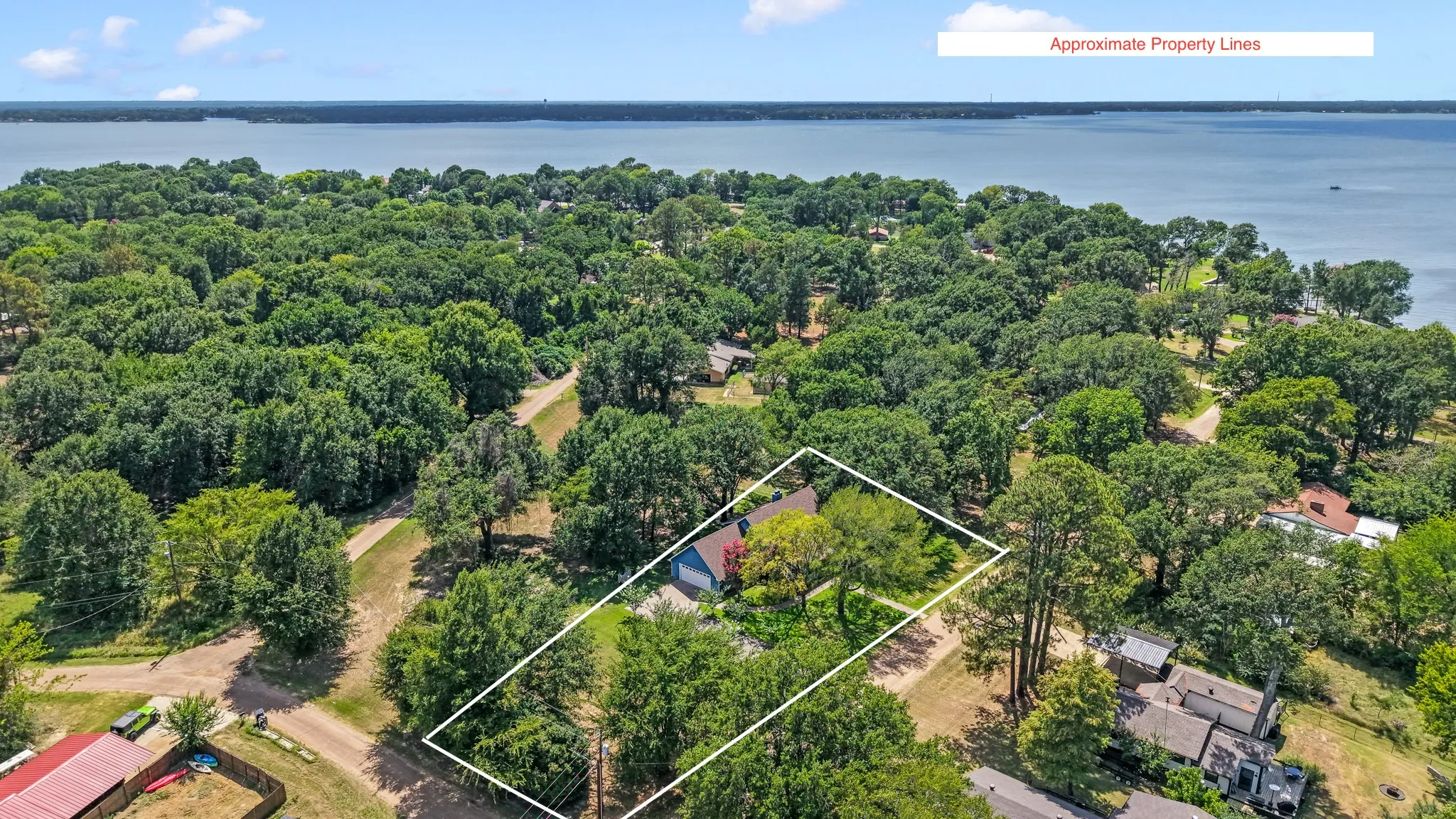 Aerial view highlighting the oversized double lot and close proximity to the lake.