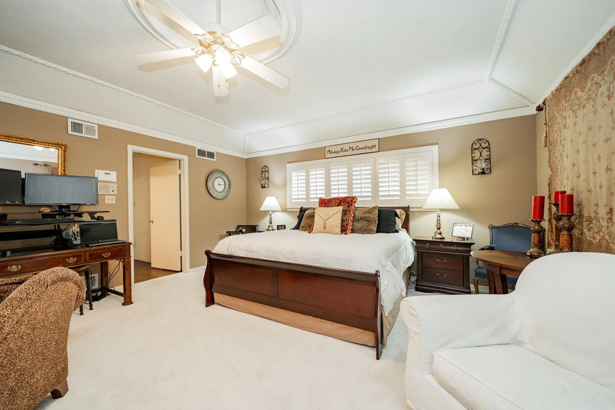 Carpeted bedroom with ceiling fan