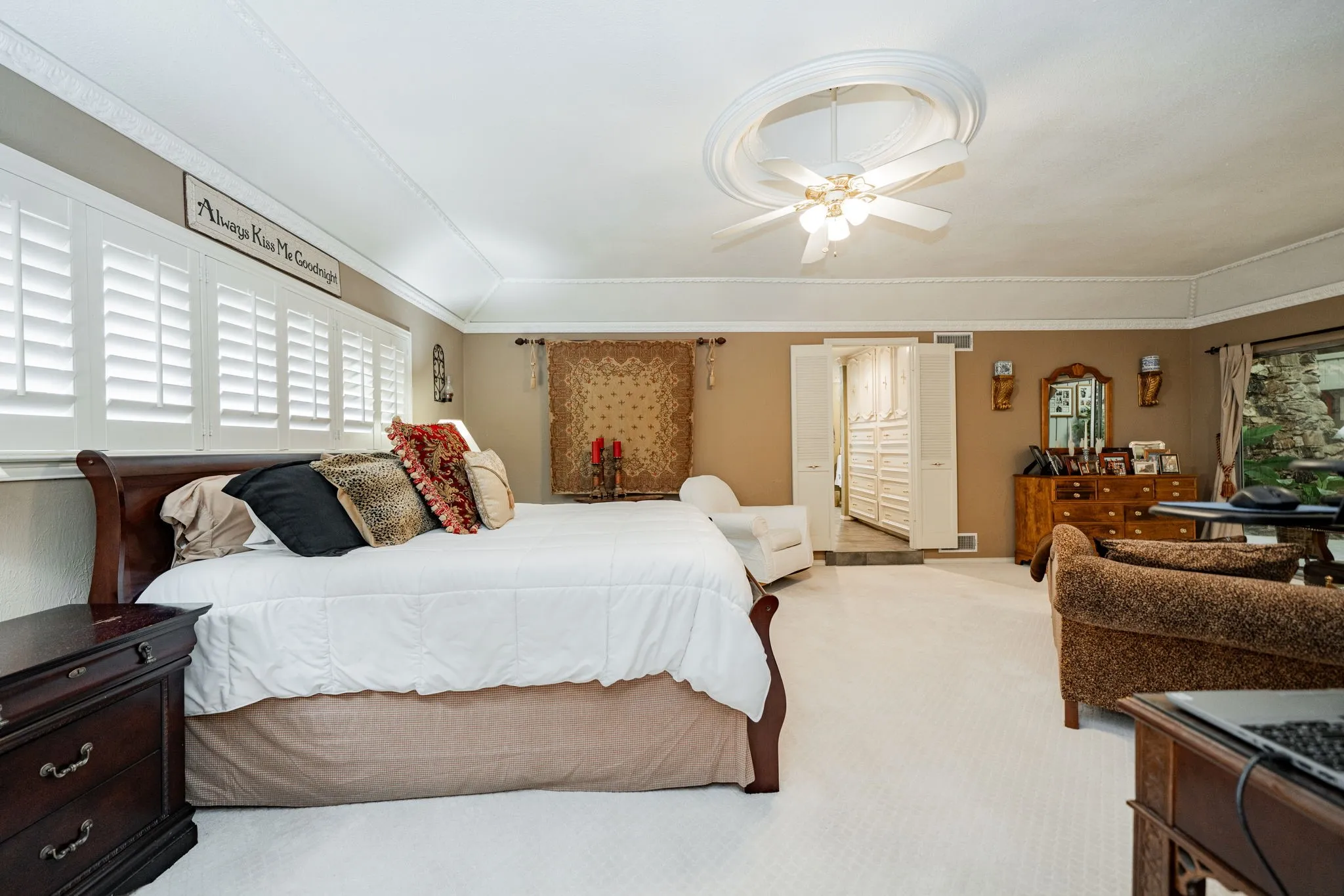 Carpeted bedroom with ceiling fan
