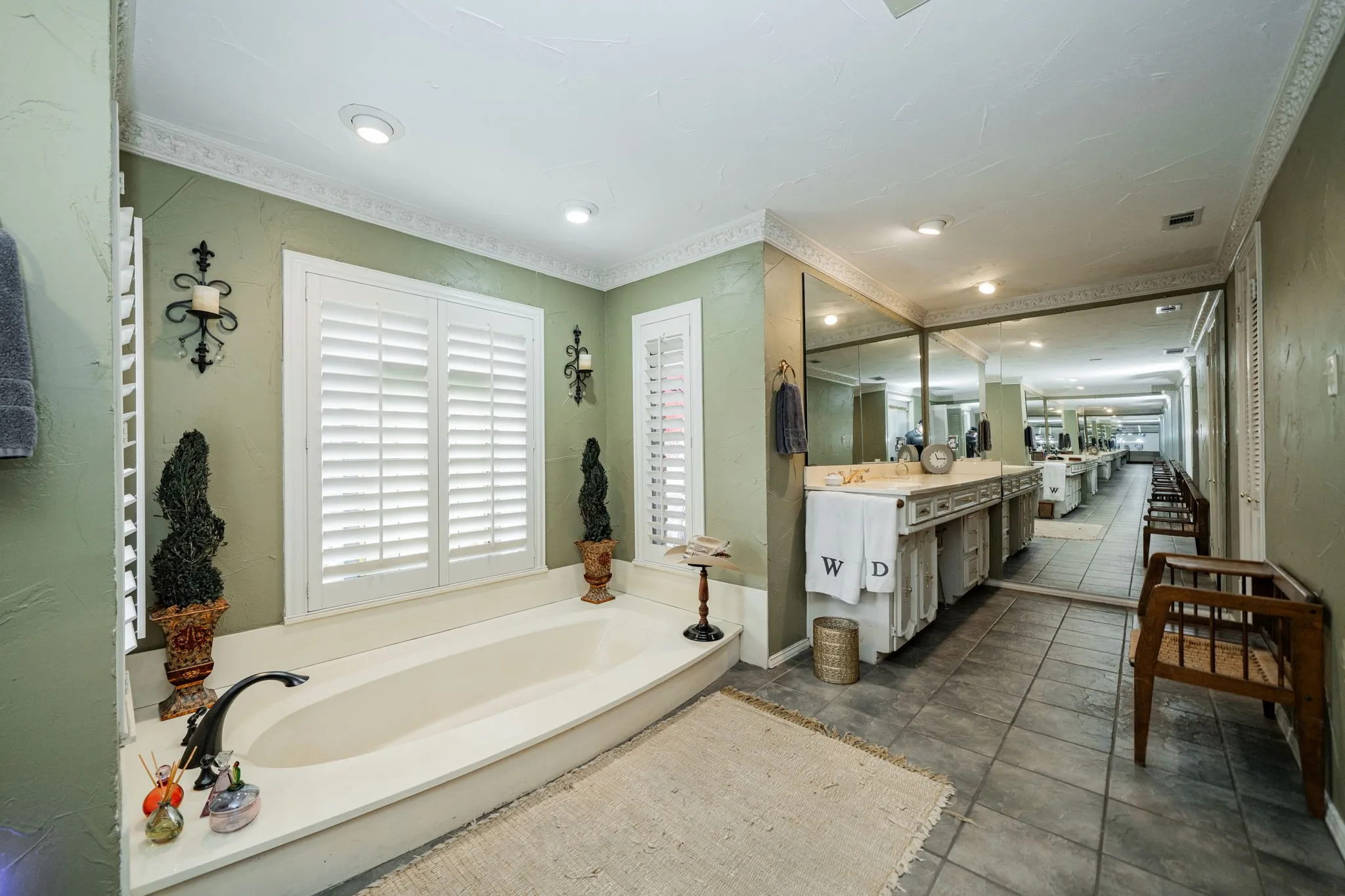 Full bathroom featuring vanity, a bath, ornamental molding, recessed lighting, and dark tile patterned floors