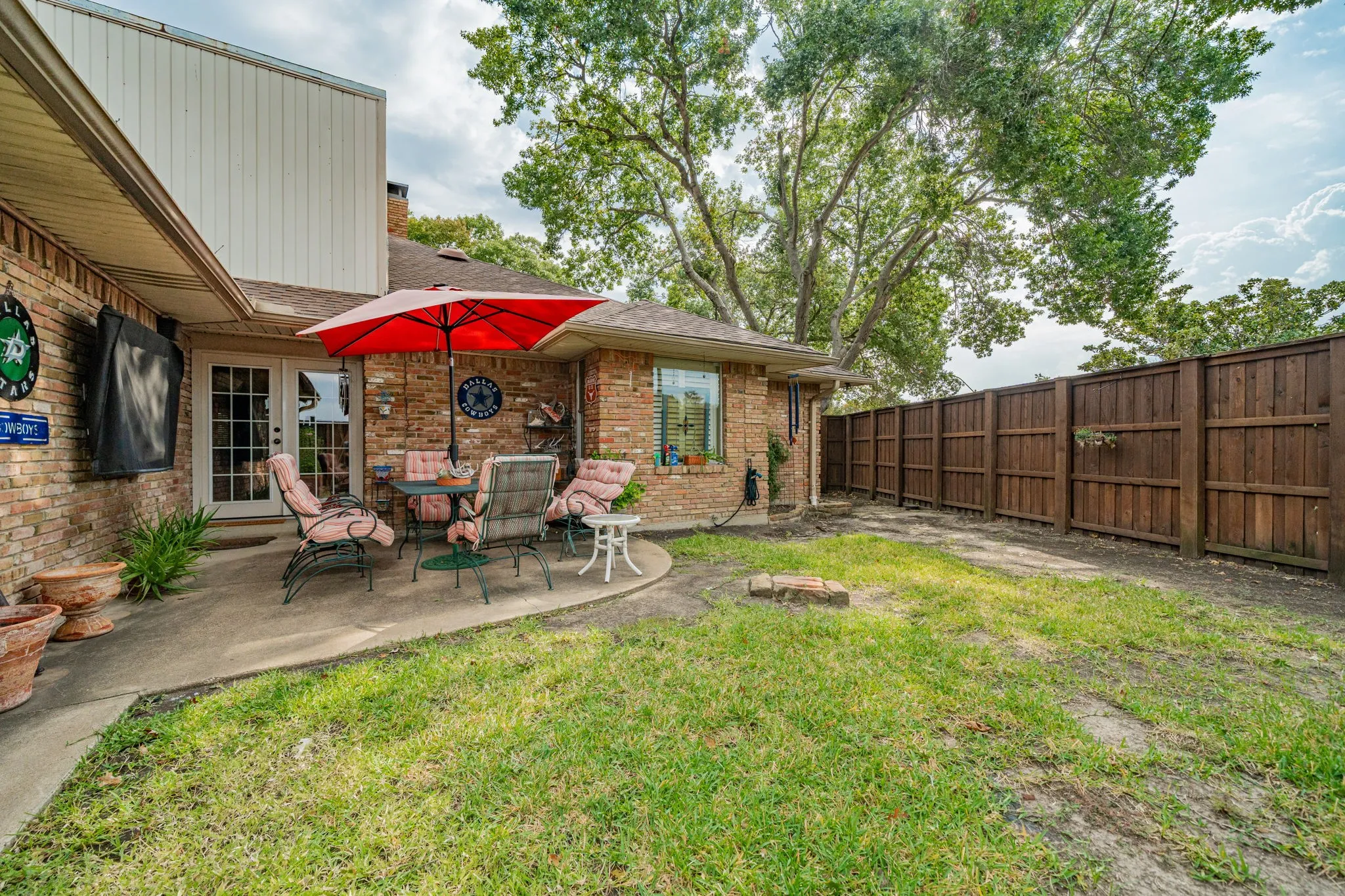Fenced backyard featuring a patio and french doors