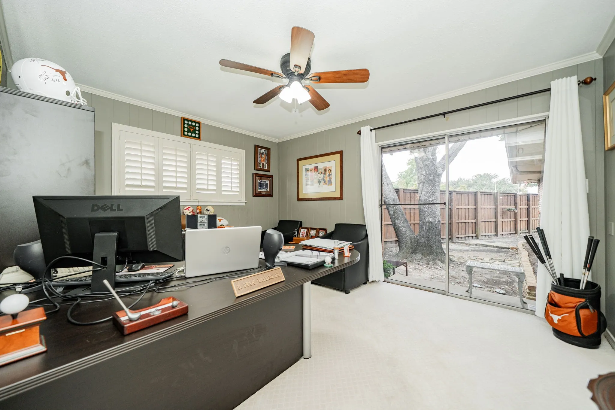 Office space with crown molding, light carpet, and a ceiling fan