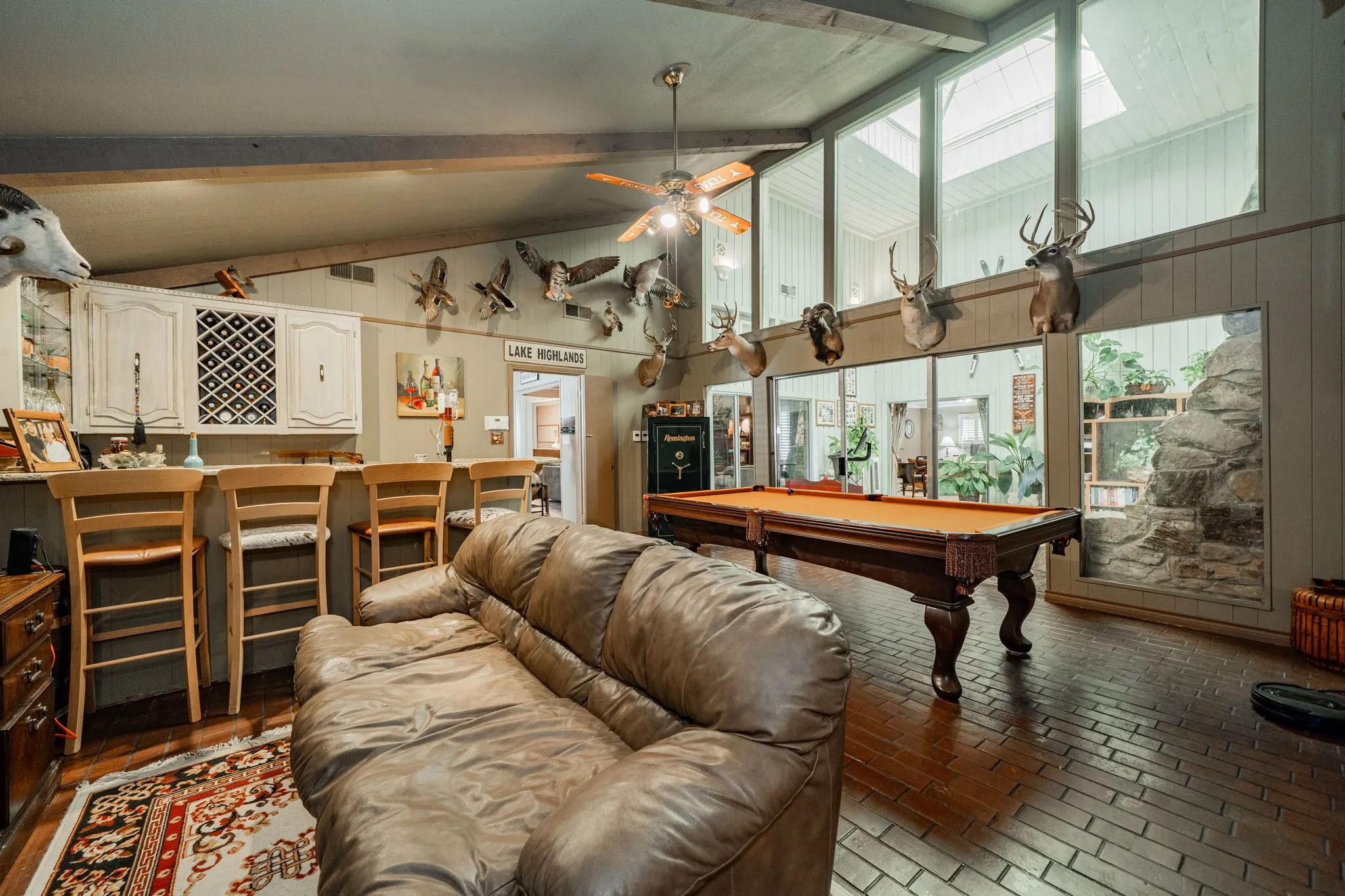 Game room featuring beamed ceiling, billiards table, high vaulted ceiling, brick floors, and ceiling fan