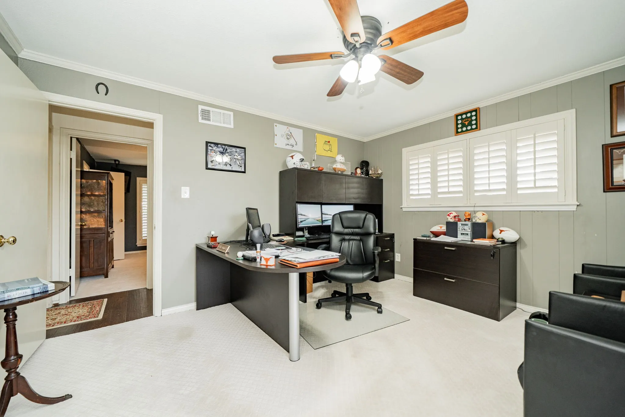 Office area featuring ornamental molding, carpet flooring, and ceiling fan