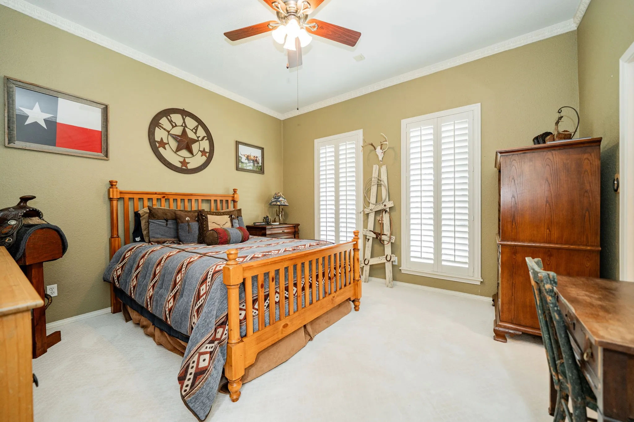 Bedroom featuring light carpet, crown molding, and ceiling fan