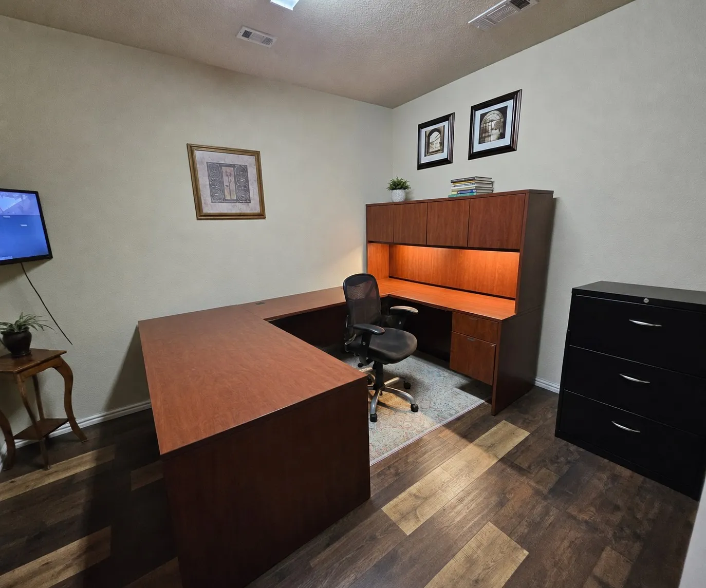 Dedicated workspace featuring wood-finish flooring and light-toned walls