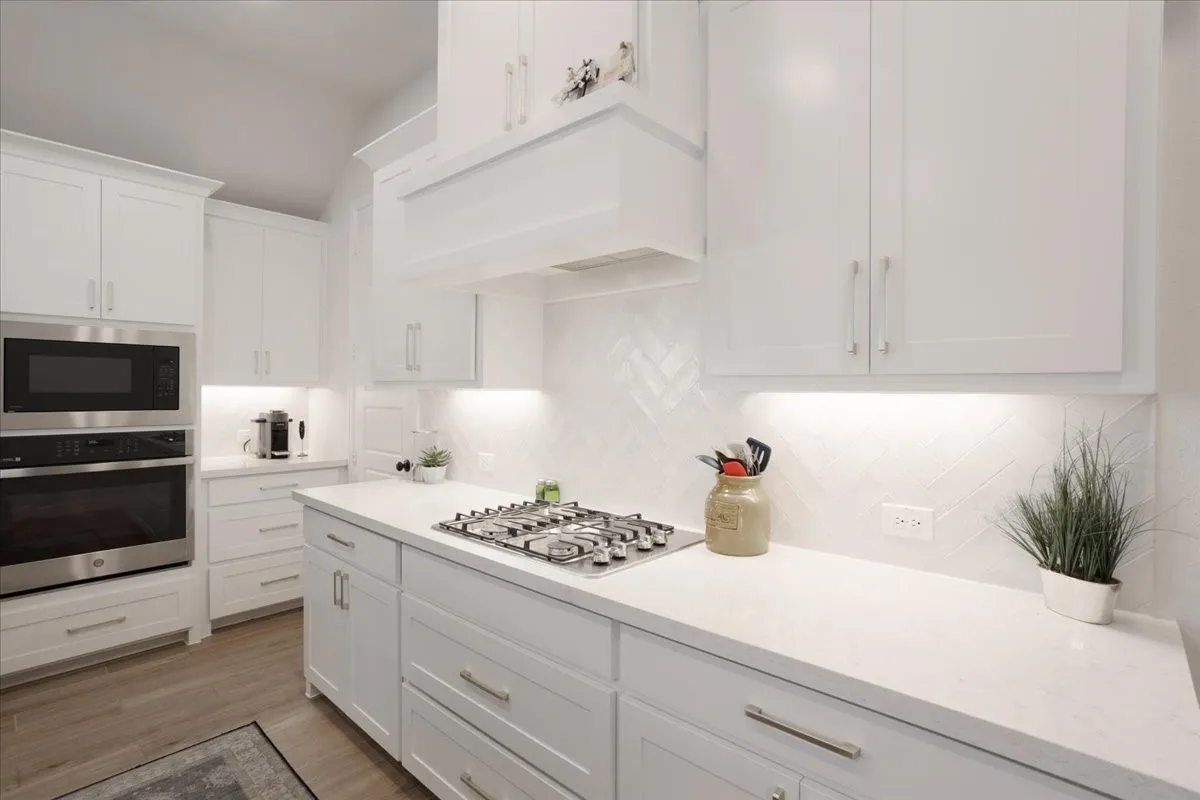 The kitchen features a gas range and stainless steel appliances.