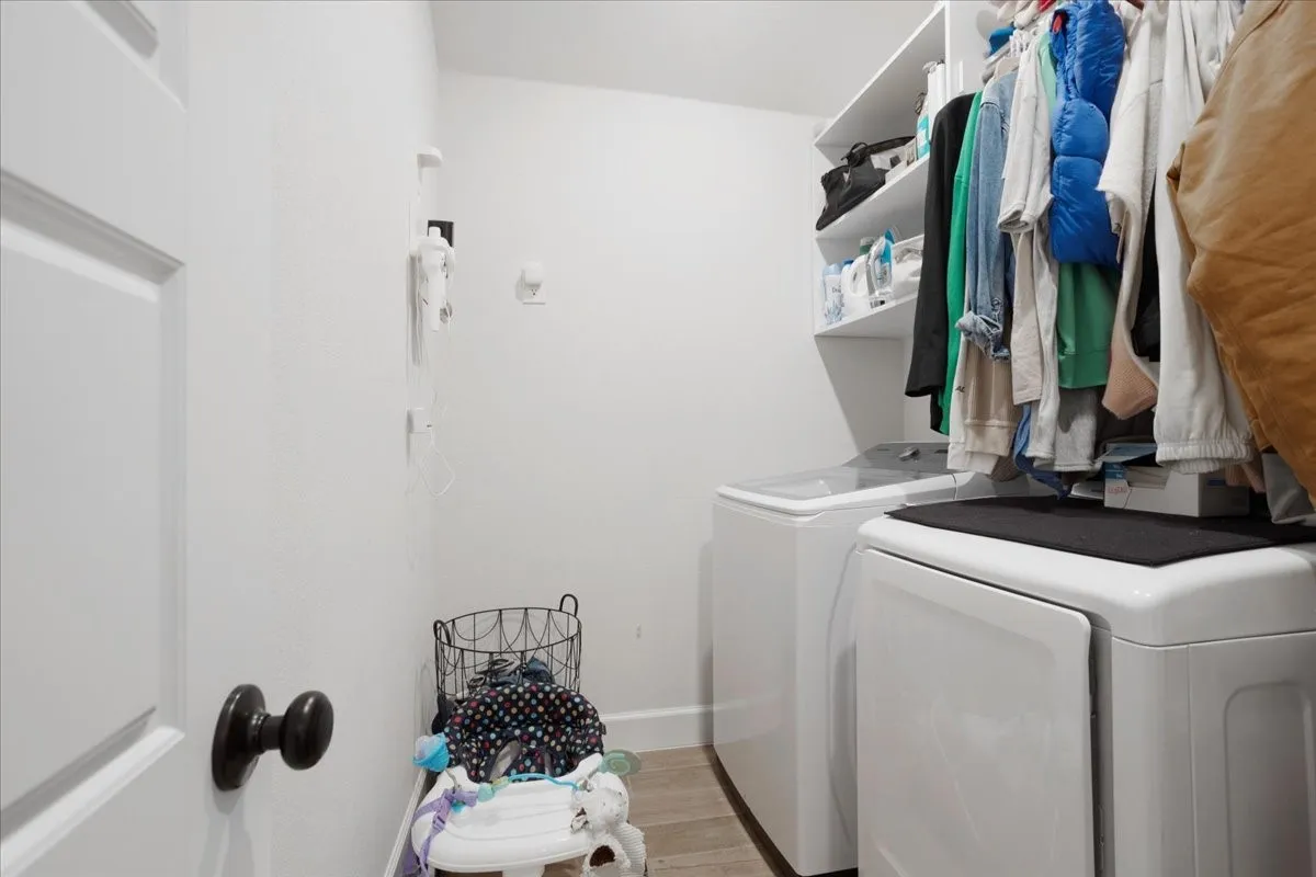 This laundry is so spacious and is it's own space located in the hall.
