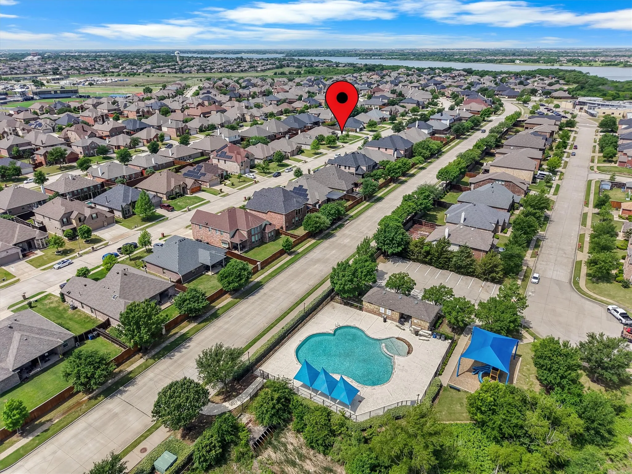 Aerial perspective of a residential community featuring a variety of single-family homes with diverse architectural styles and rooflines