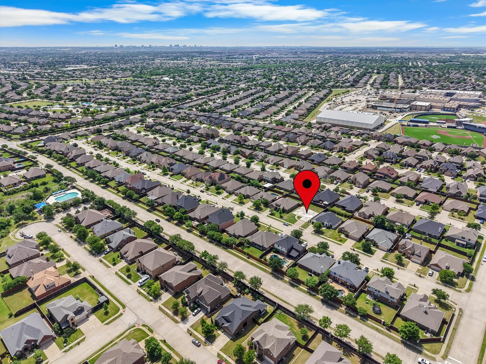 Expansive residential neighborhood featuring numerous single-family homes with diverse architectural styles, visible from an aerial perspective