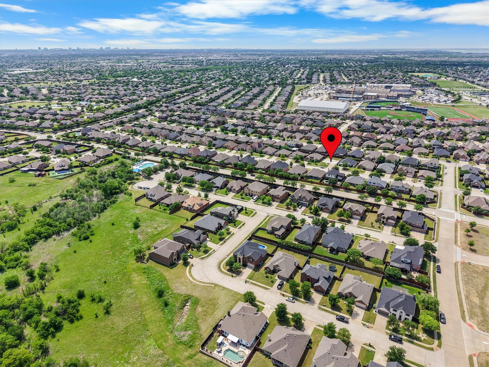 Expansive residential area featuring numerous single-family homes with diverse architectural styles, visible streets, and mature trees