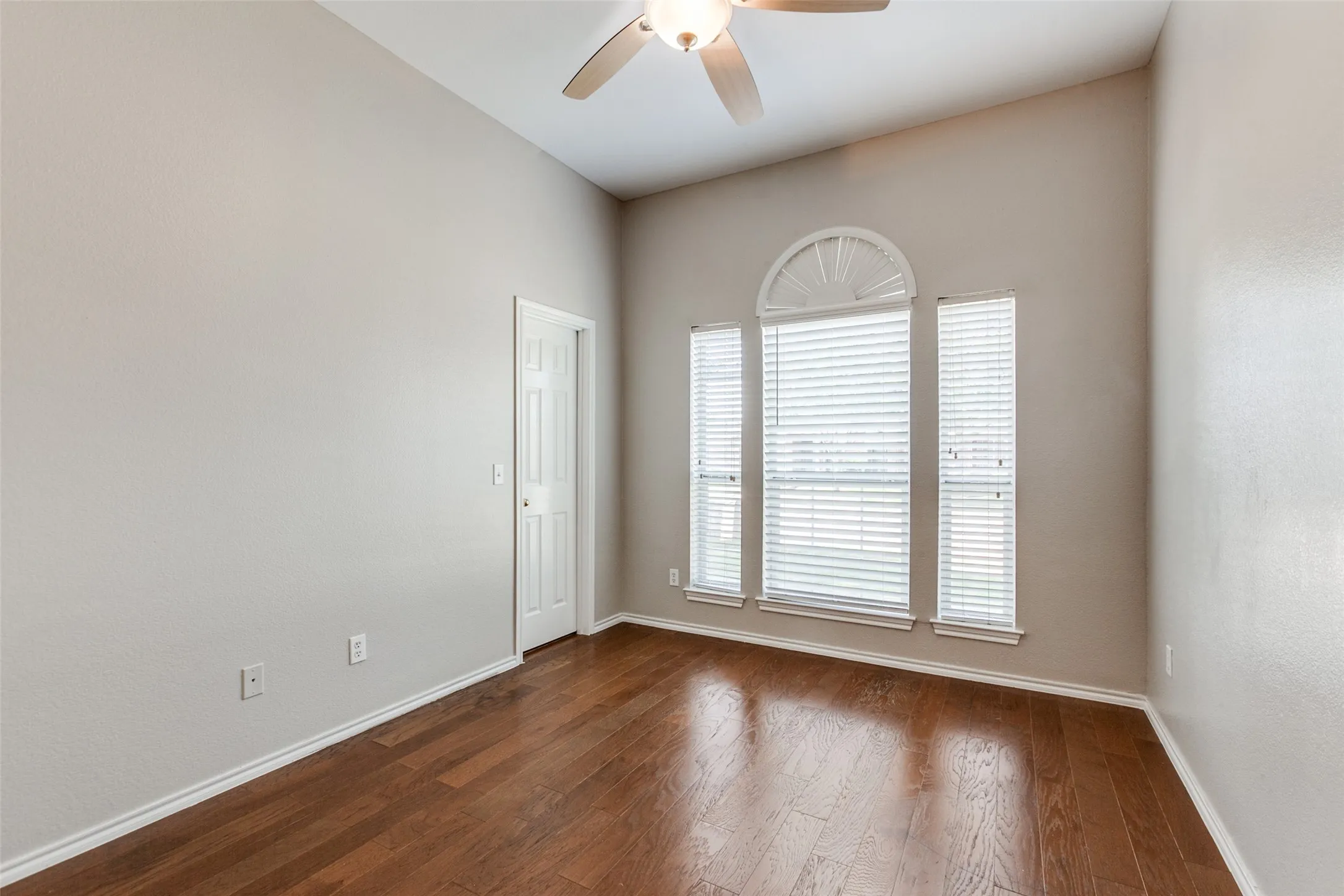 Room with vaulted ceiling, wood-finish flooring, and a ceiling fan