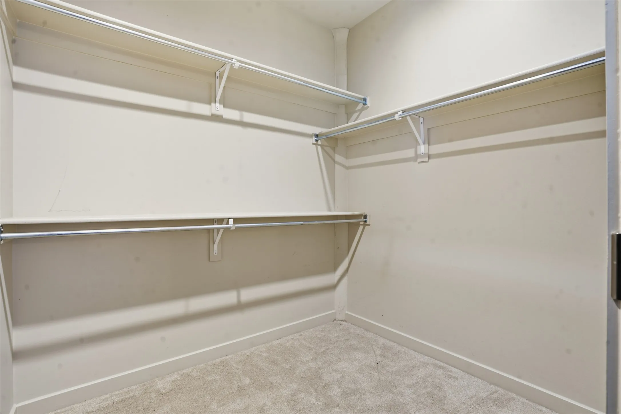Walk-in closet featuring extensive shelving and hanging rods