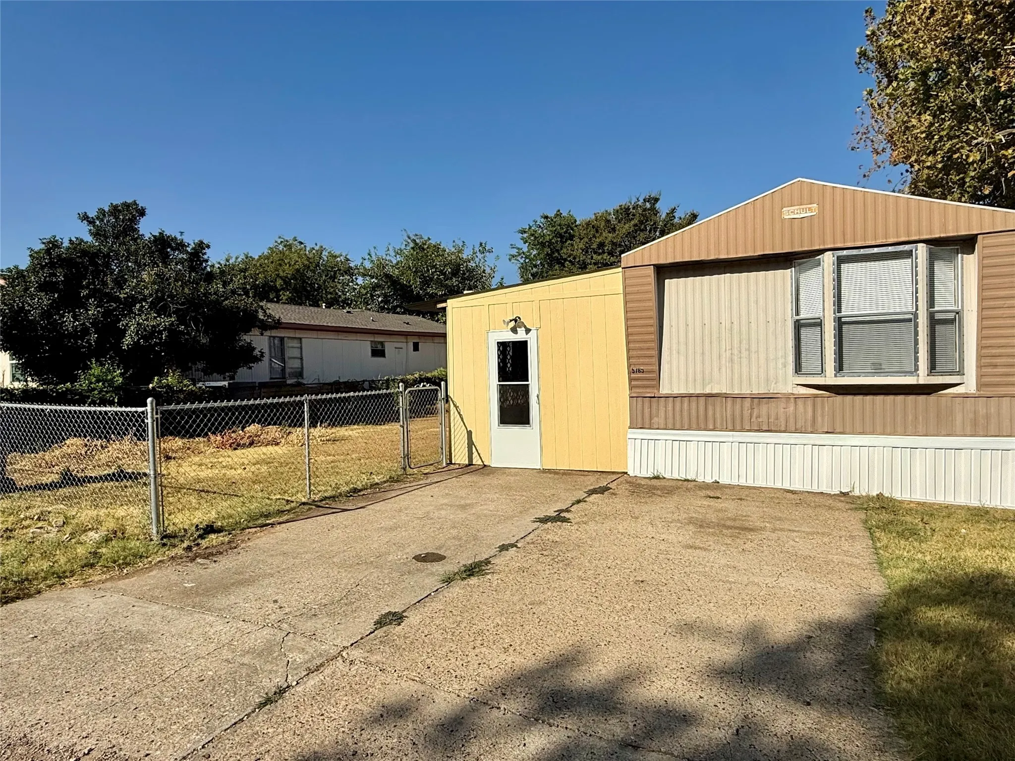 Exterior with multi-toned siding, bay window, and concrete driveway