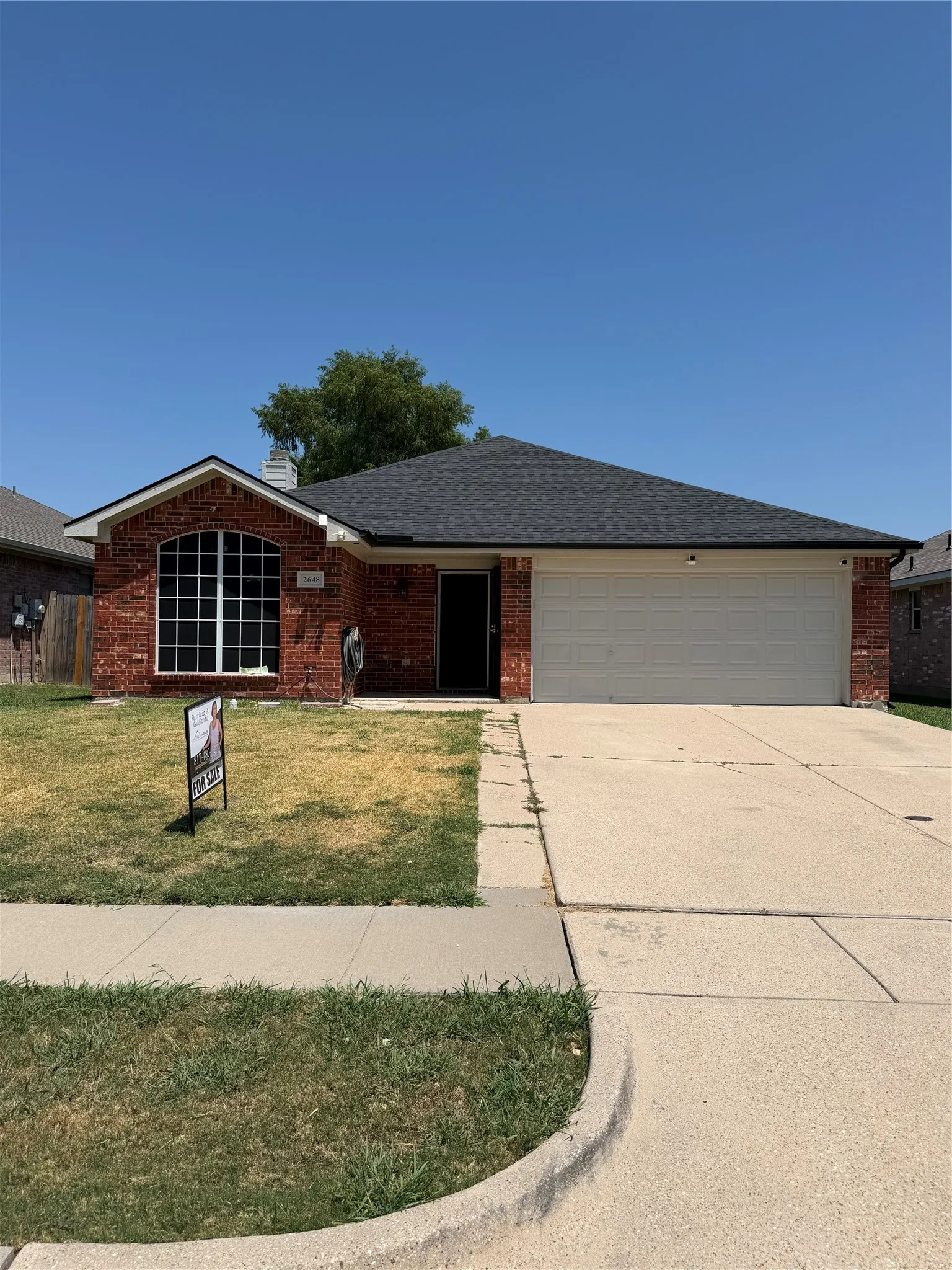Brick and siding exterior with an attached two-car garage