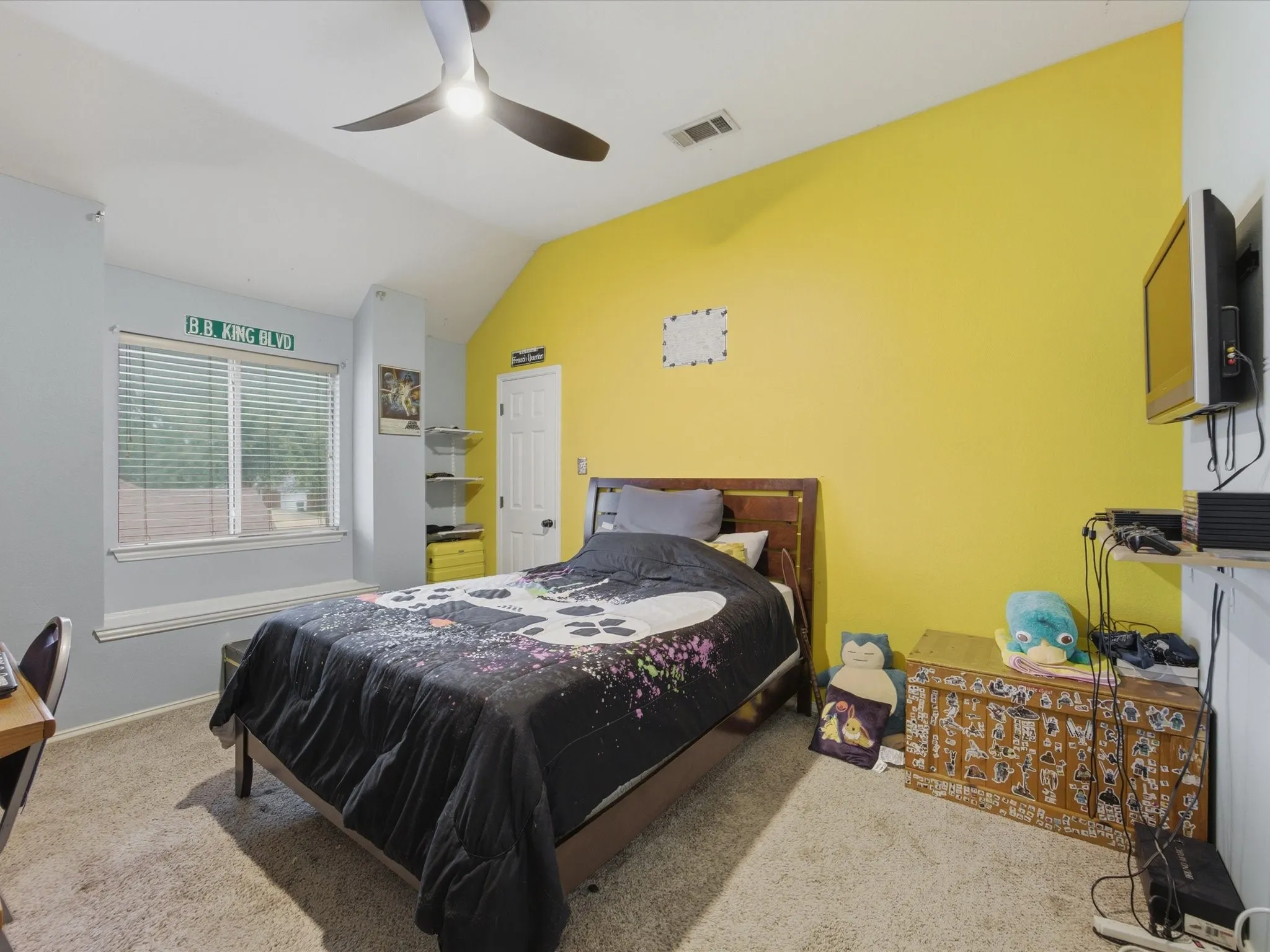 Carpeted room featuring a ceiling fan with integrated lighting, a window with blinds, and an integrated window bench