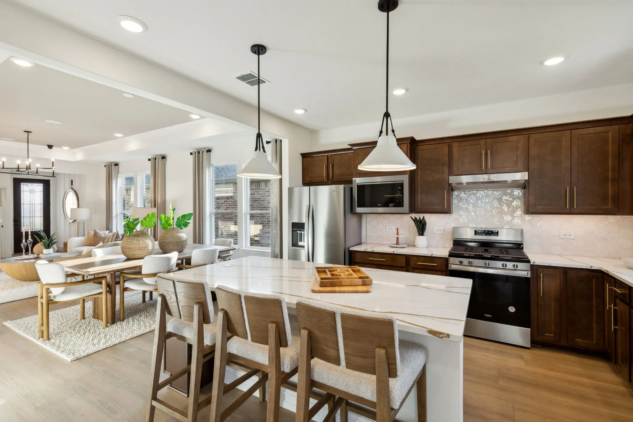 *Model Representation - Large island overlooking gathering room and dining areas