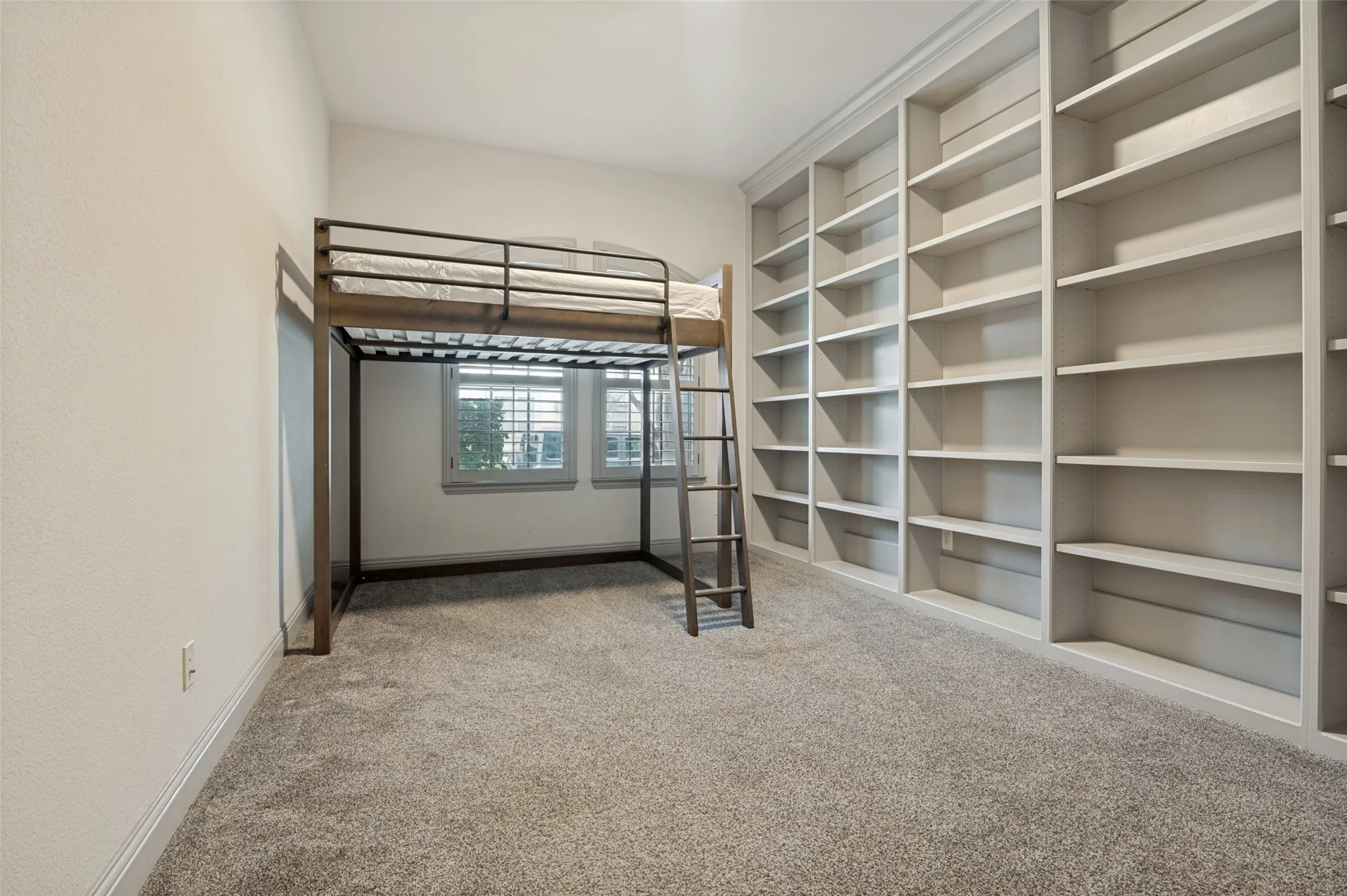 Built-in wall-to-wall shelving provides extensive storage and display options