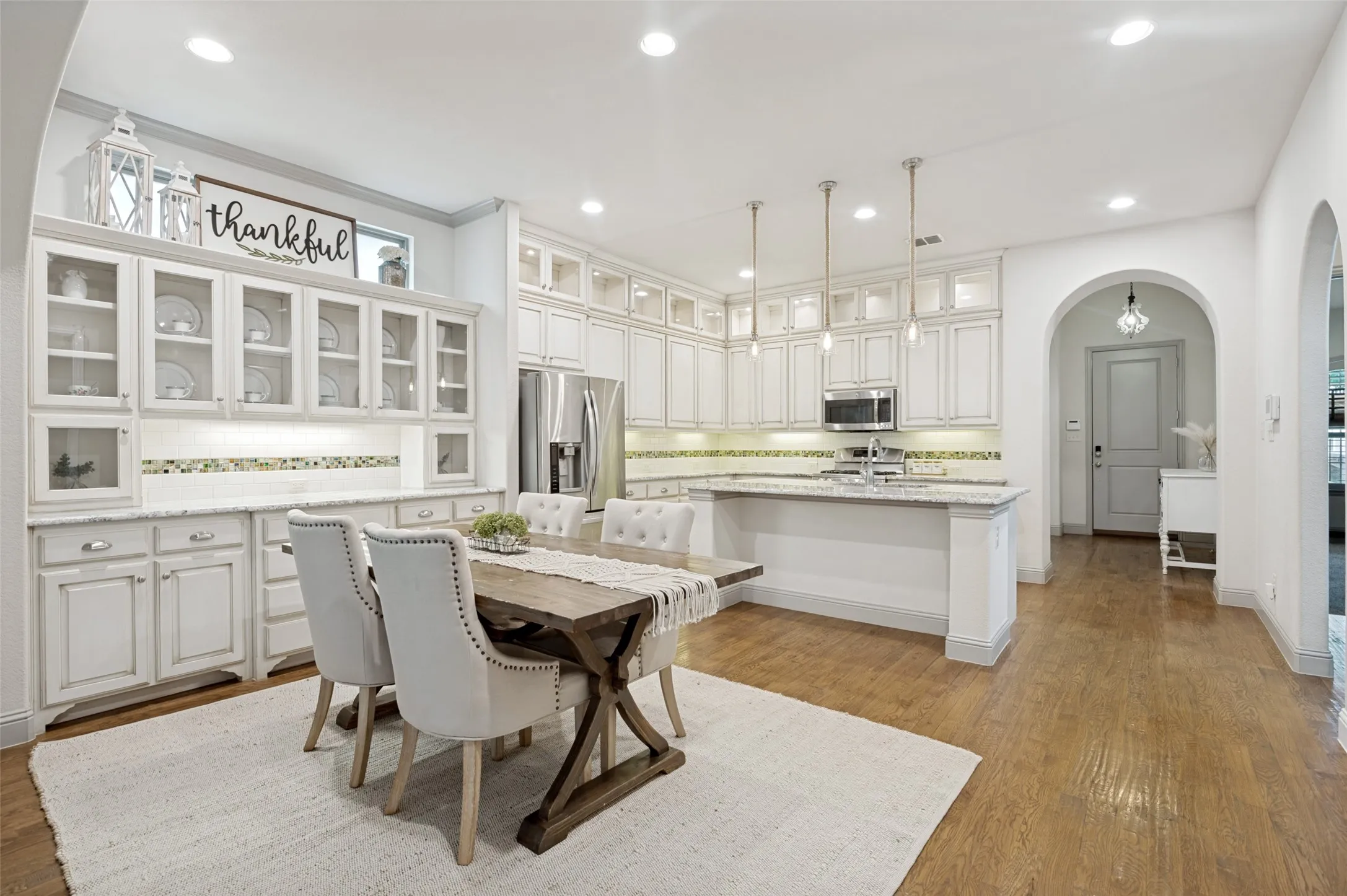 Open-concept kitchen and dining area featuring light wood-finish flooring