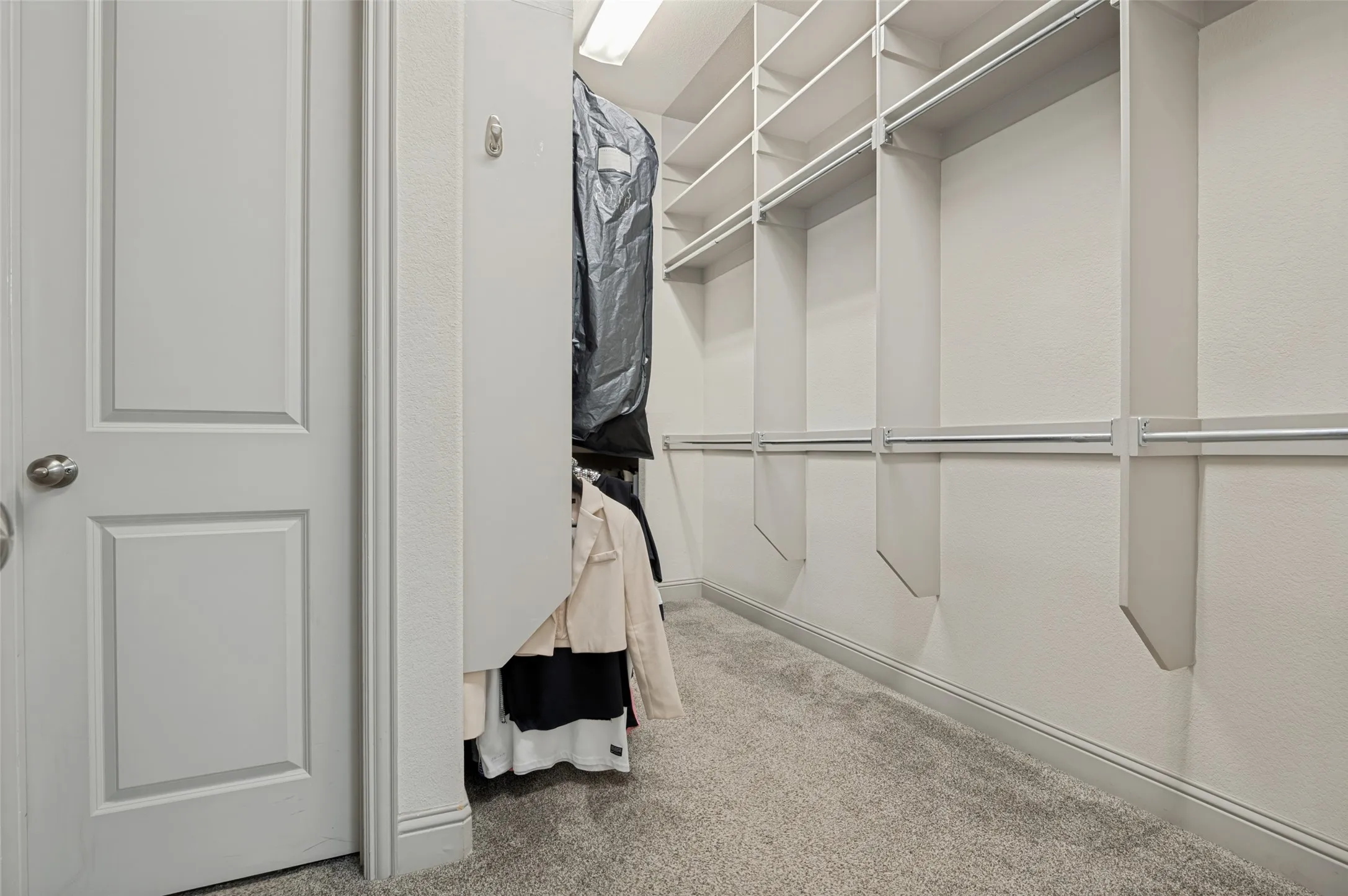 Custom closet system featuring multiple shelves and hanging rods