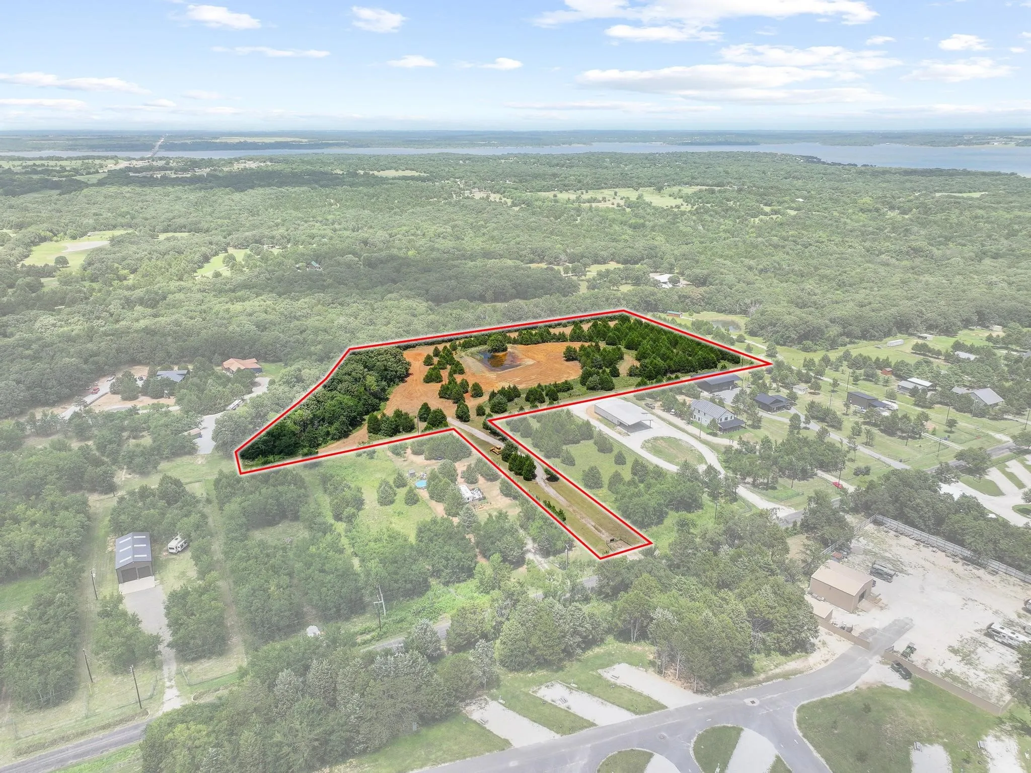 Expansive land parcel featuring a mix of open terrain and mature trees