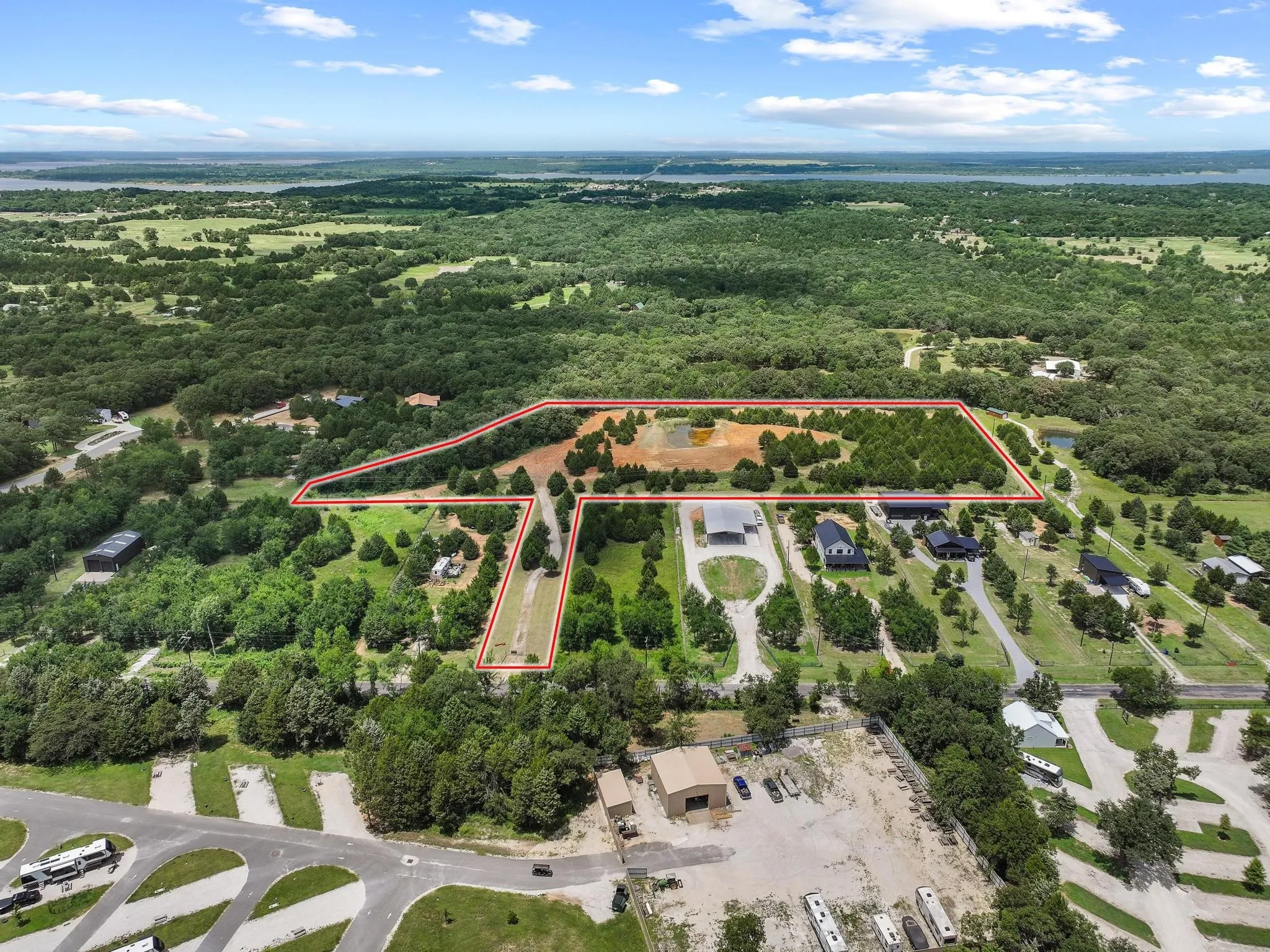Expansive acreage featuring a substantial cleared area, mature trees