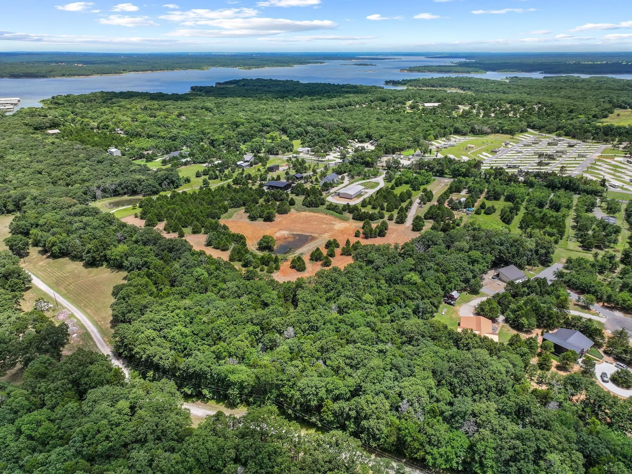 Expansive acreage featuring abundant mature trees, multiple clearings, and water feature