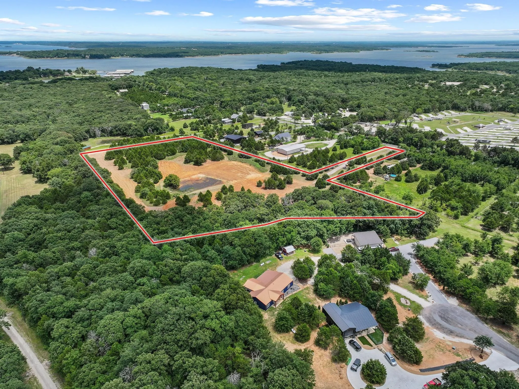 Expansive acreage bordered by mature trees and featuring a partial clearing