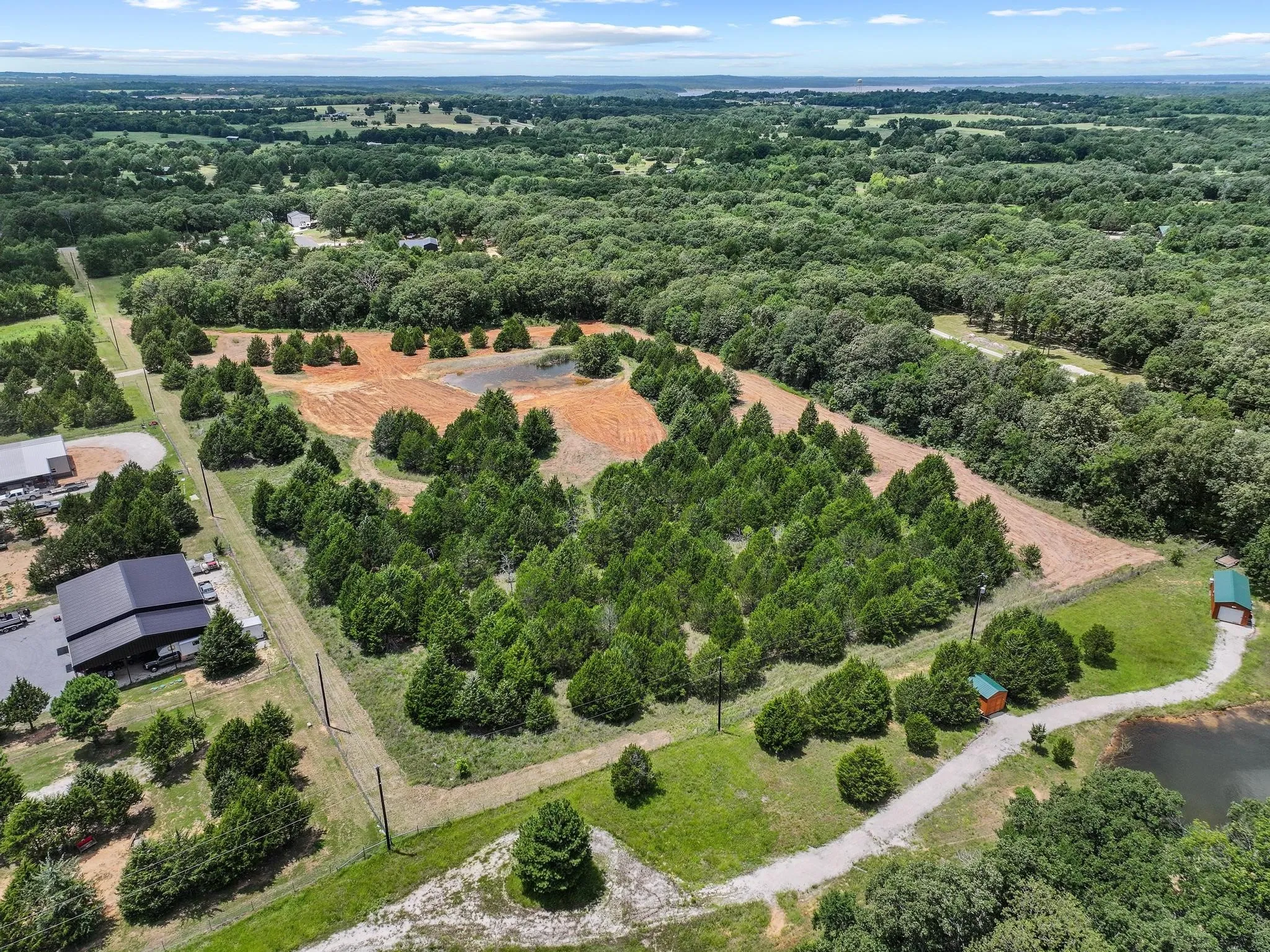Expansive acreage featuring abundant mature trees, multiple cleared areas