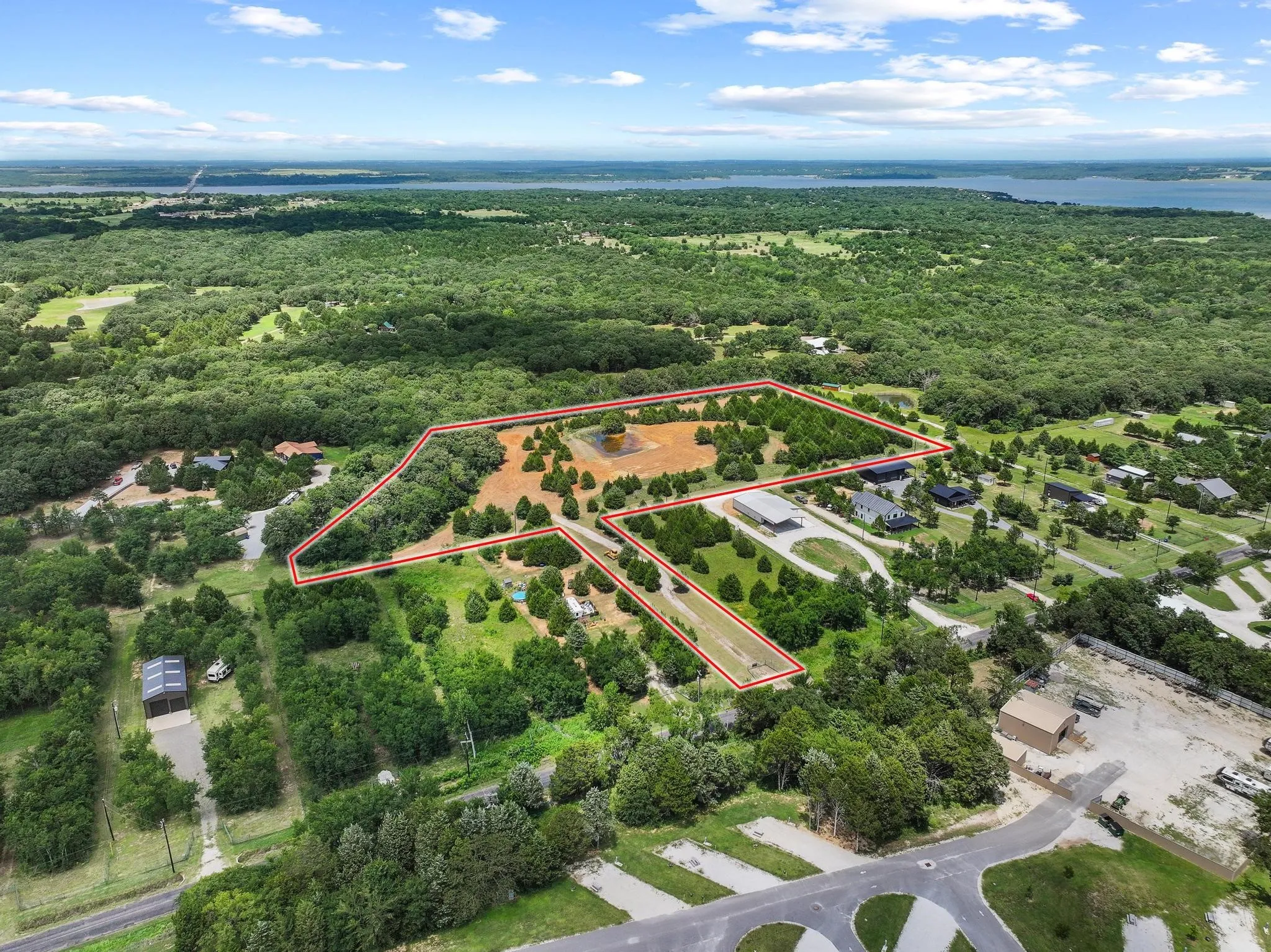 Expansive lot featuring a mix of cleared land and mature trees, surrounded by extensive natural foliage