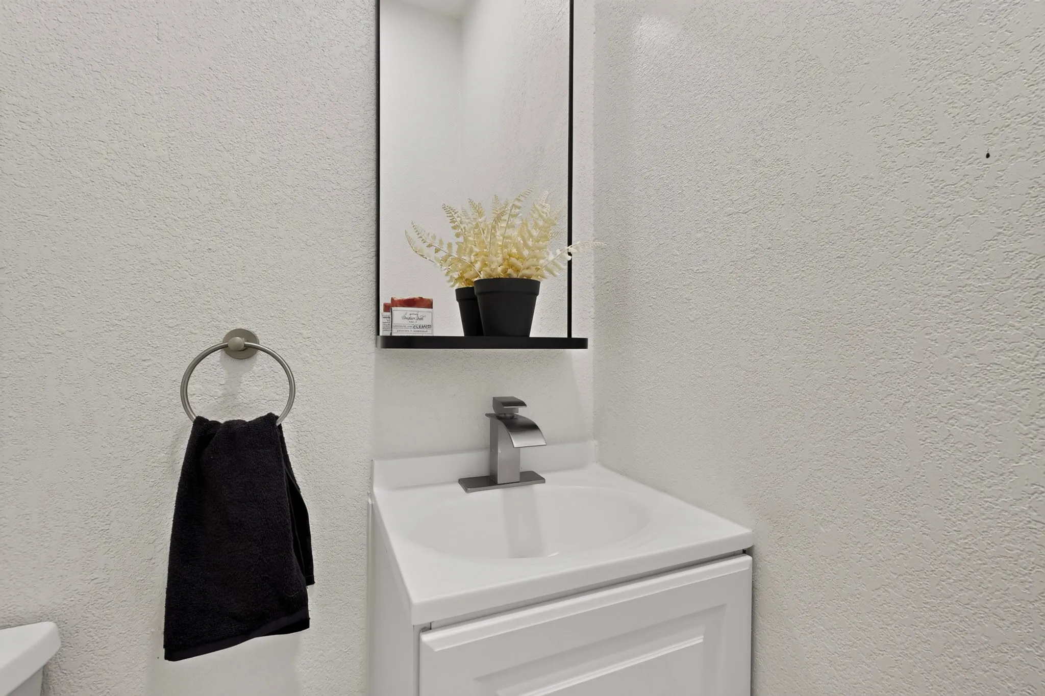 Vanity with integrated sink and chrome faucet