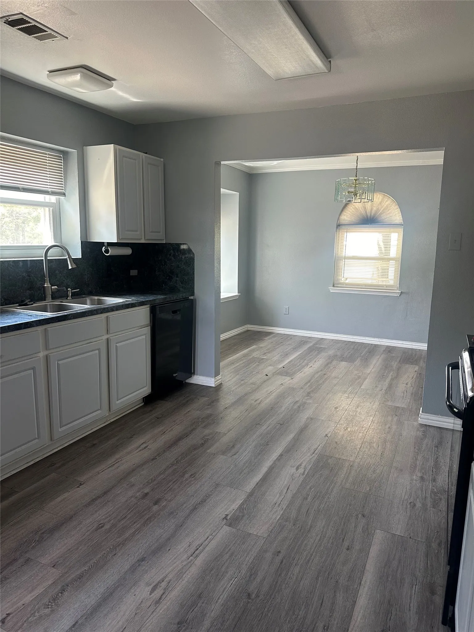 Kitchen and dining area featuring wood-finish flooring