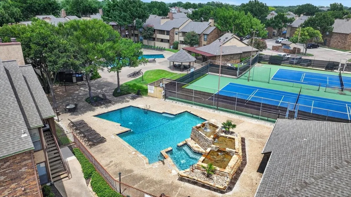 Community amenities featuring a swimming pool with a rock waterfall, a secondary wading pool, two tennis courts, and a covered gazebo