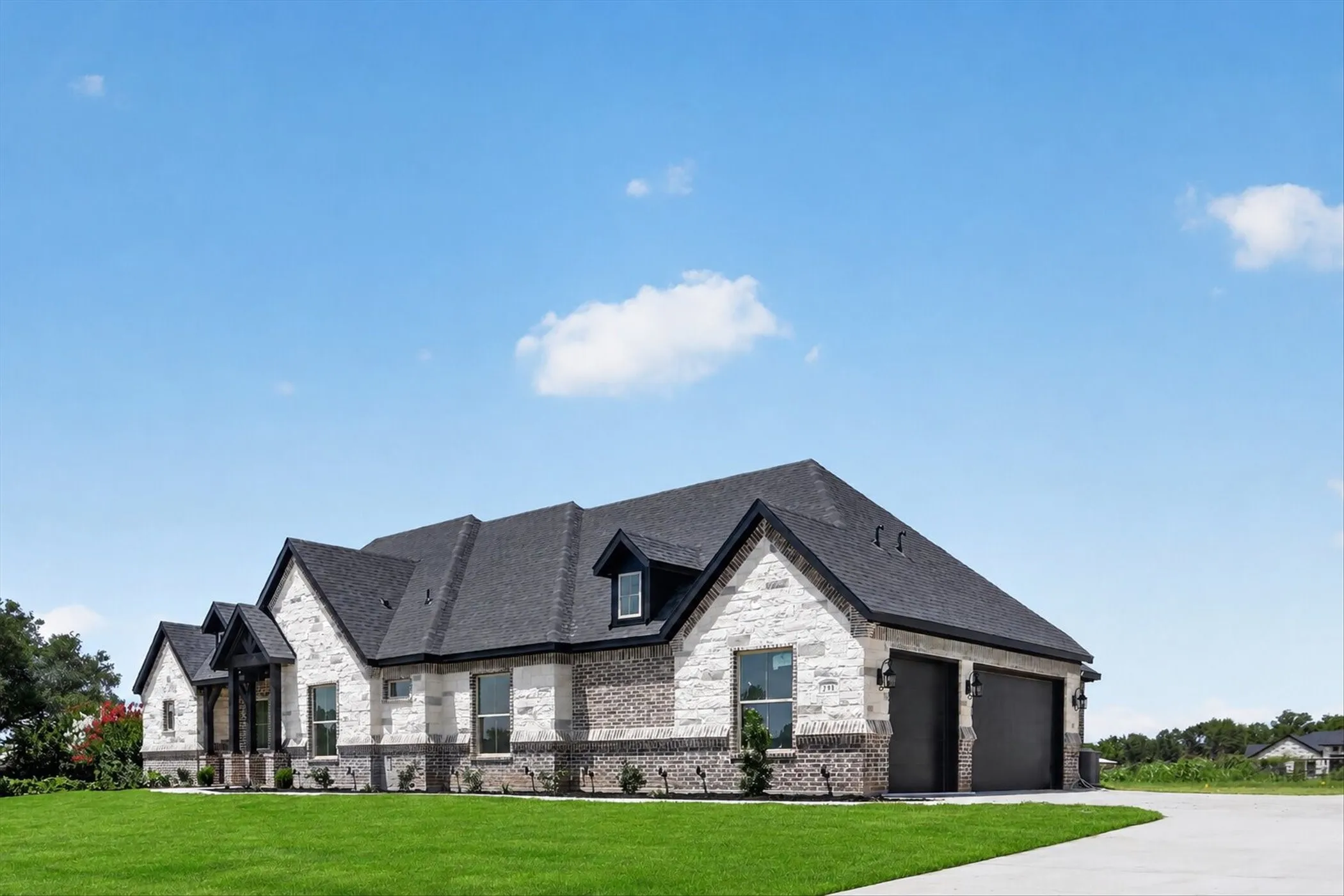 Stone and brick exterior with a dark shingle roof