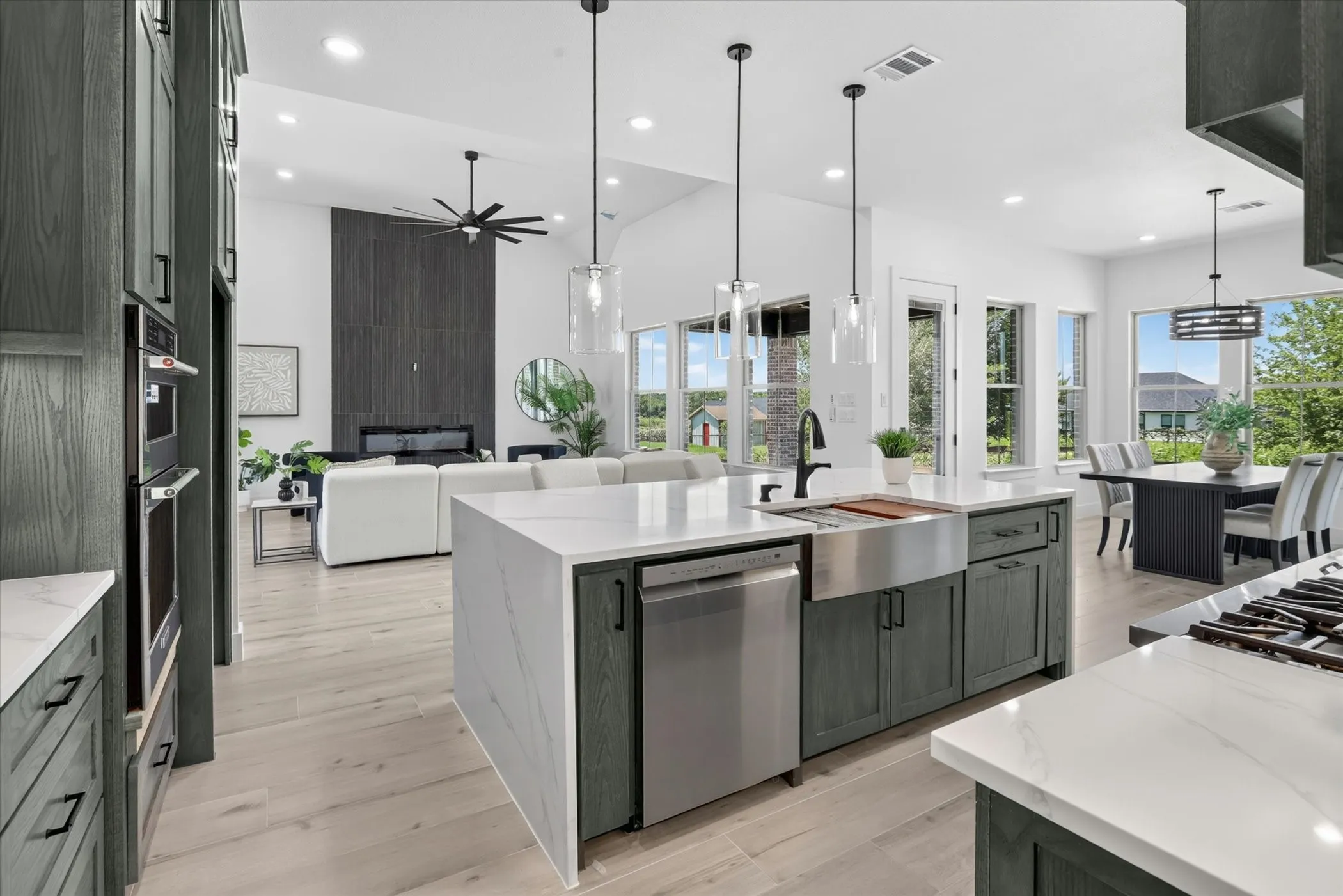 Kitchen island with waterfall countertop and undermount stainless steel farmhouse sink
