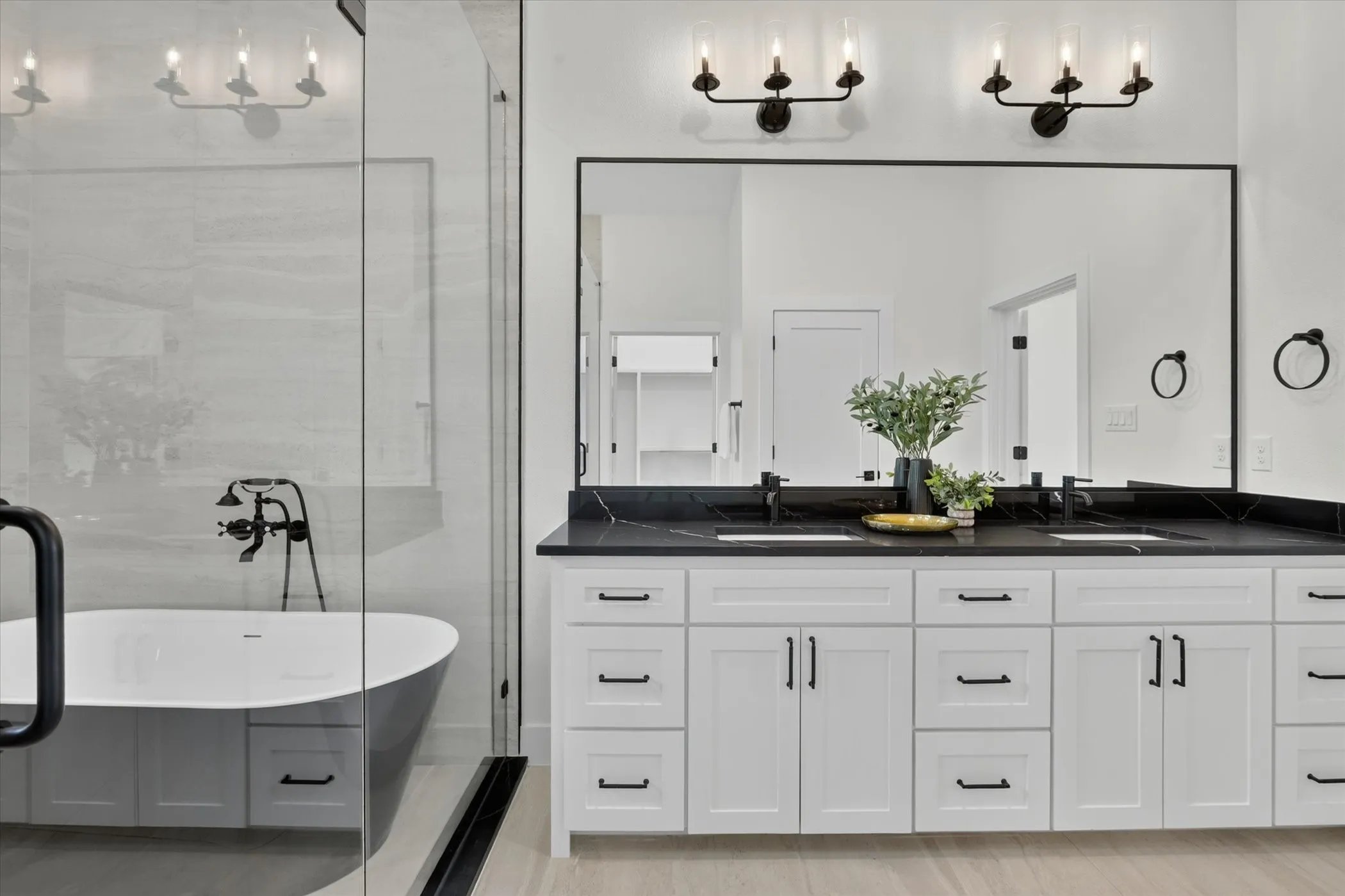 Contemporary bathroom featuring a freestanding soaking tub, a frameless glass shower enclosure, a%2