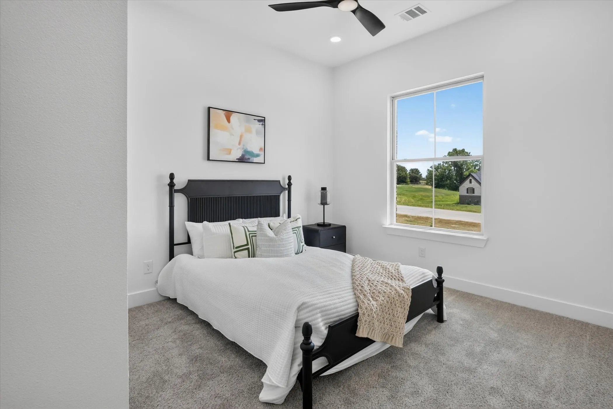 Bright room with a large window, recessed lighting, and a ceiling fan