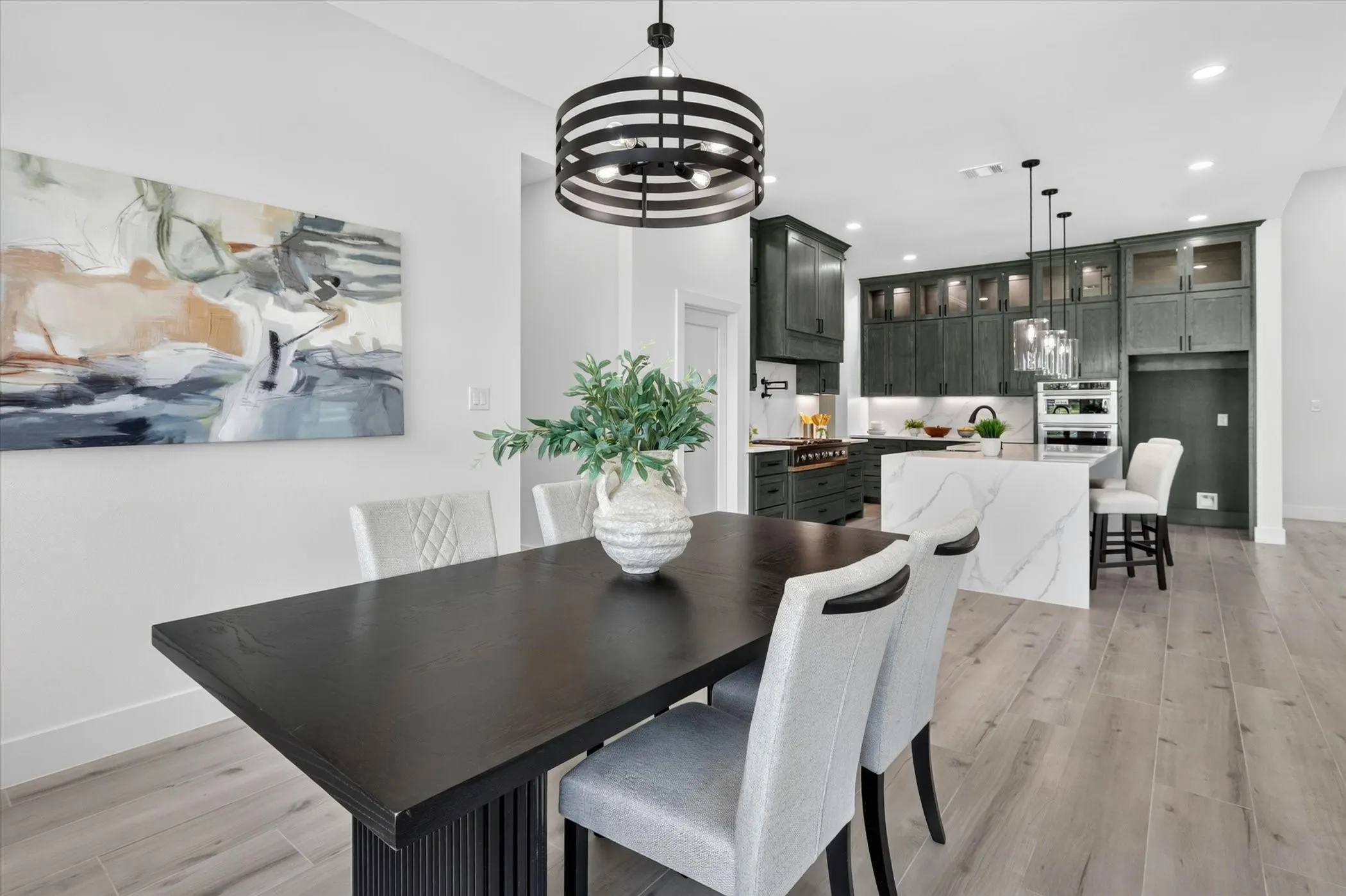 Dining area featuring a contemporary black dining table and light wood-finish flooring