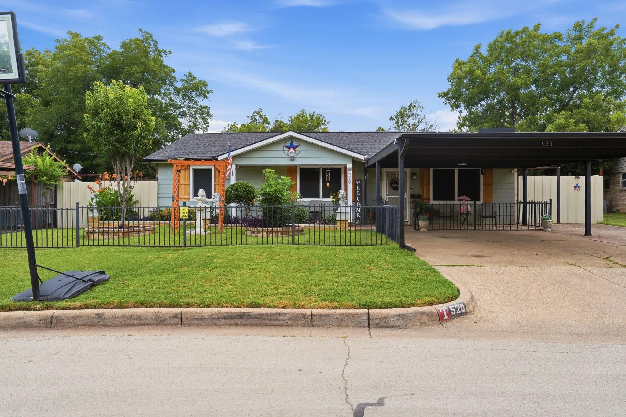 Single-story residence featuring light blue siding and a dark shingle roof